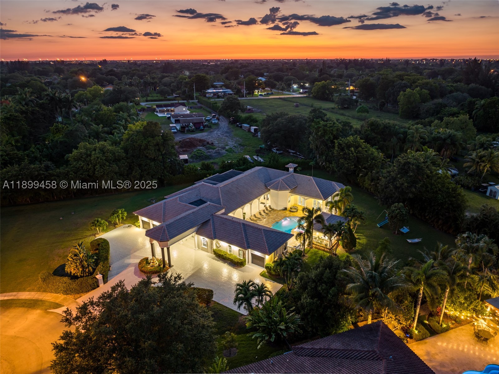 Most homes offer space—this one delivers scale, lifestyle, and presence at a completely different level. Tucked away on a quiet cul-de-sac in Davie, this impressive estate spans over 7,000 sq ft with 9 bedrooms and 7 bathrooms, designed for those who want room to live, entertain, and truly spread out.

From the moment you enter, soaring ceilings and expansive open living areas create a grand first impression. Natural light pours through the home, highlighting the scale of each space. The layout is thoughtfully designed for both everyday living and large gatherings, with a seamless flow between the chef’s kitchen, multiple living areas, and entertainment spaces.

This home is built for lifestyle. Enjoy a private cinema, game room, and dedicated gym, creating a full in-home experience without ever needing to leave. Every room feels oversized, every space intentional—perfect for large families, multi-generational living, or hosting at a high level.

Step outside and the property truly separates itself. The backyard is a resort-style retreat on a massive lot, featuring a heated pool, spa, hammocks, and a full BBQ area. The scale of the outdoor space is exceptional—offering privacy, openness, and the kind of setting that feels like a private resort. Whether entertaining guests or enjoying quiet nights under the stars, this is where the home truly shines.