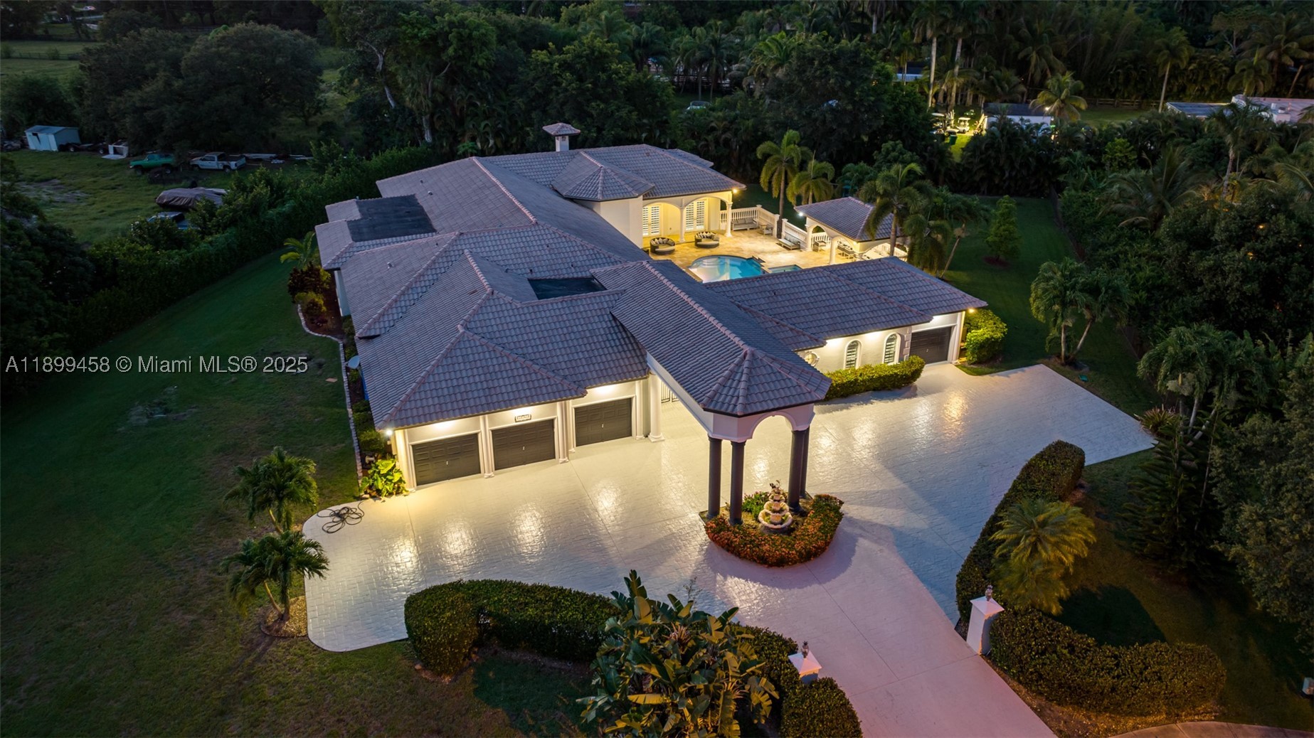 Most homes offer space—this one delivers scale, lifestyle, and presence at a completely different level. Tucked away on a quiet cul-de-sac in Davie, this impressive estate spans over 7,000 sq ft with 9 bedrooms and 7 bathrooms, designed for those who want room to live, entertain, and truly spread out.

From the moment you enter, soaring ceilings and expansive open living areas create a grand first impression. Natural light pours through the home, highlighting the scale of each space. The layout is thoughtfully designed for both everyday living and large gatherings, with a seamless flow between the chef’s kitchen, multiple living areas, and entertainment spaces.

This home is built for lifestyle. Enjoy a private cinema, game room, and dedicated gym, creating a full in-home experience without ever needing to leave. Every room feels oversized, every space intentional—perfect for large families, multi-generational living, or hosting at a high level.

Step outside and the property truly separates itself. The backyard is a resort-style retreat on a massive lot, featuring a heated pool, spa, hammocks, and a full BBQ area. The scale of the outdoor space is exceptional—offering privacy, openness, and the kind of setting that feels like a private resort. Whether entertaining guests or enjoying quiet nights under the stars, this is where the home truly shines.