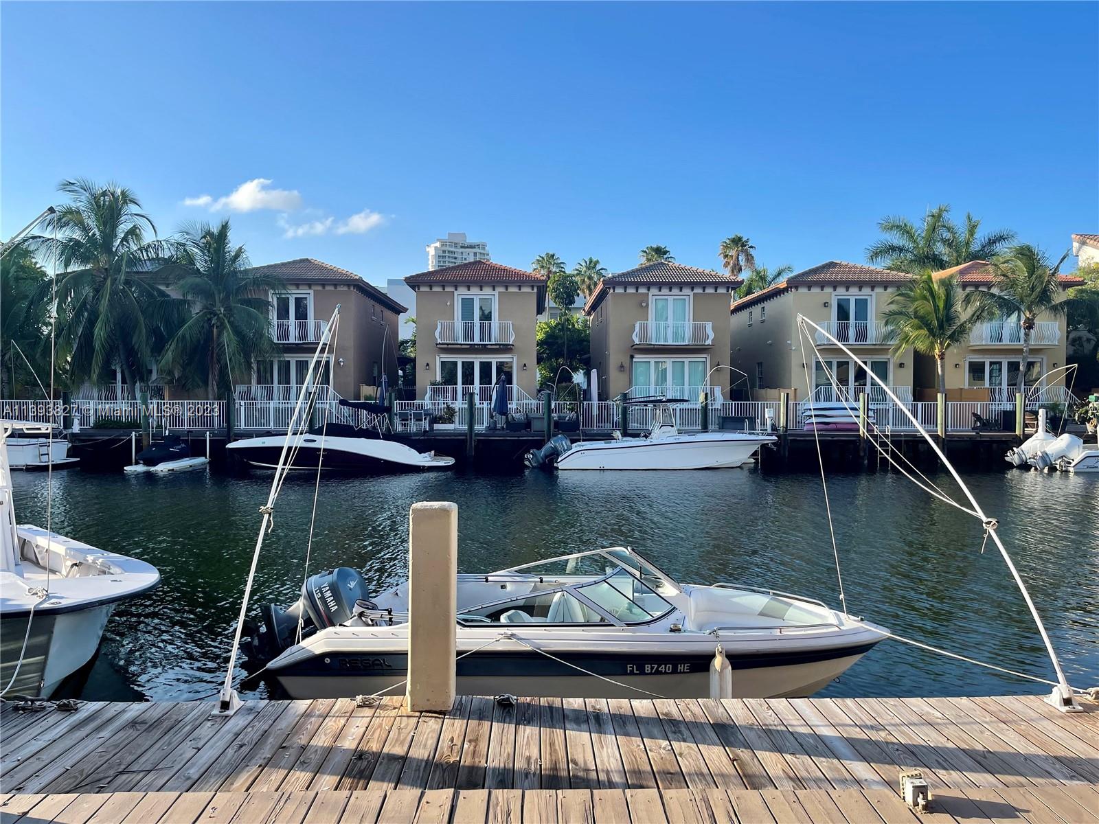 1,570 SQFT, 2 Story Townhouse with a boat dock located directly behind the unit.  Freshly painted and ready for immediate move in.  Walk to Sunny Isles Beach, dining and shopping!  Salt life with the privacy of a gated neighborhood.  Shared parking, rear deck facing the boat dock, plenty of closet space and space to entertain.