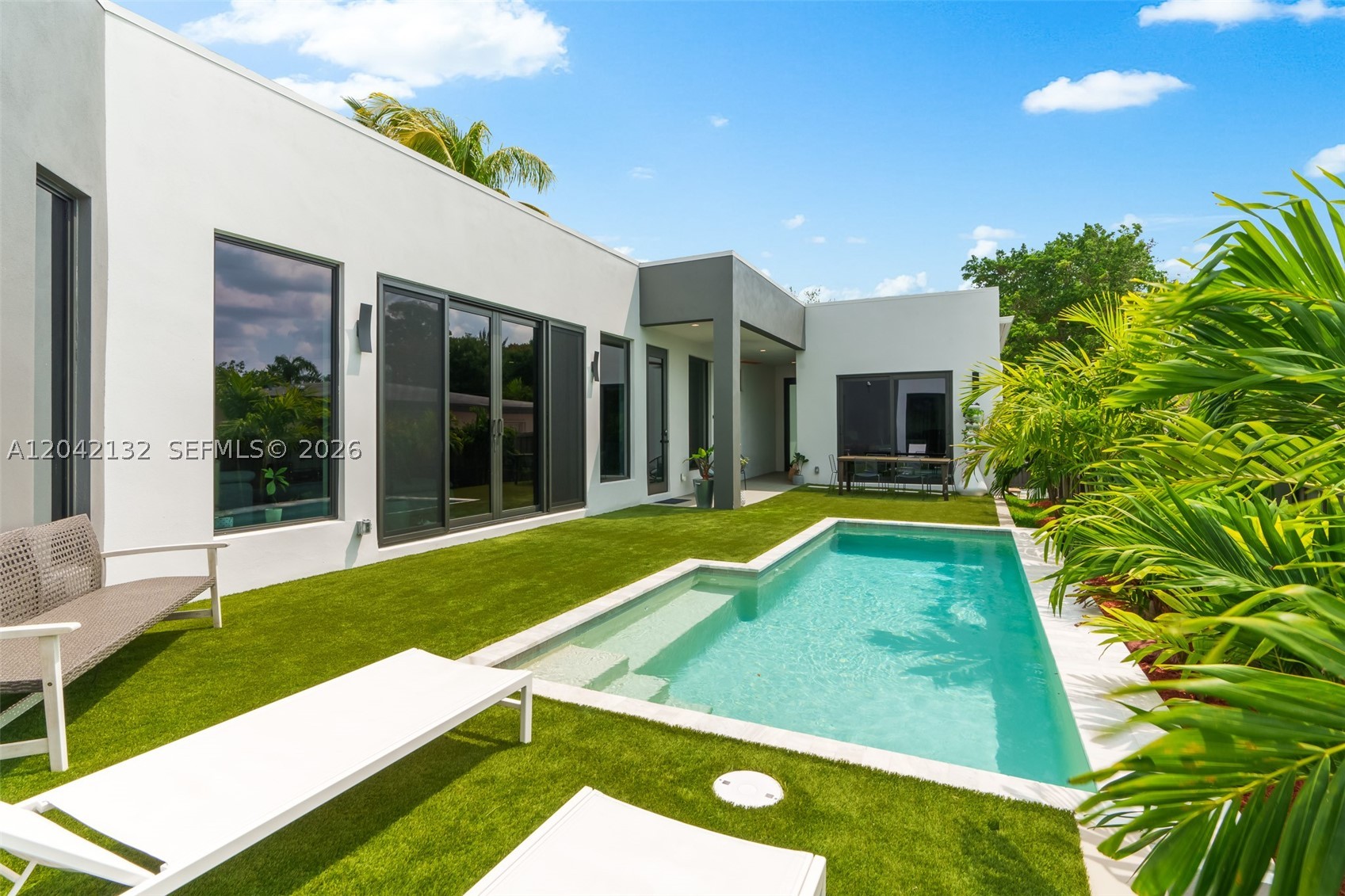Modern Luxury New Construction with Guest Cabana — Walk to Wilton Drive, No Flood Zone. One of the most affordable new-construction luxury homes in Wilton Manors, this 2023 residence blends modern design, high-end finishes, and smart sustainability in a prime walkable location. The main home offers bright, open living spaces, soaring ceilings, and a chef’s kitchen with a 10-foot island made for entertaining. The expansive primary suite features a huge walk-in closet and a spa-inspired bath with iconic Italian designer fixtures, including the award-winning Rapsel Arne soaking tub and Fantini dual shower system. Outdoors, enjoy a heated salt-water pool surrounded by lush tropical landscaping. The detached pool cabana includes an ensuite bath, kitchenette, private entrance, and a proven 5.0-star Airbnb history generating over $25,000 annually — enough to cover the property taxes. Built for peace of mind, the home features solid concrete panel construction, hurricane-impact doors and windows, elevated street-level design, solar panels, EV charger, and heat pump water heater. Located outside the flood zone, no flood insurance is required. Highlights include 4 bedrooms, 4 bathrooms including cabana, generous kitchen cabinet and storage space, luxury fixtures, privacy, low-maintenance new construction, income potential, and a quiet street just blocks from Wilton Drive. This is more than a home — it’s a lifestyle, an investment, and a rare Wilton Manors opportunity.