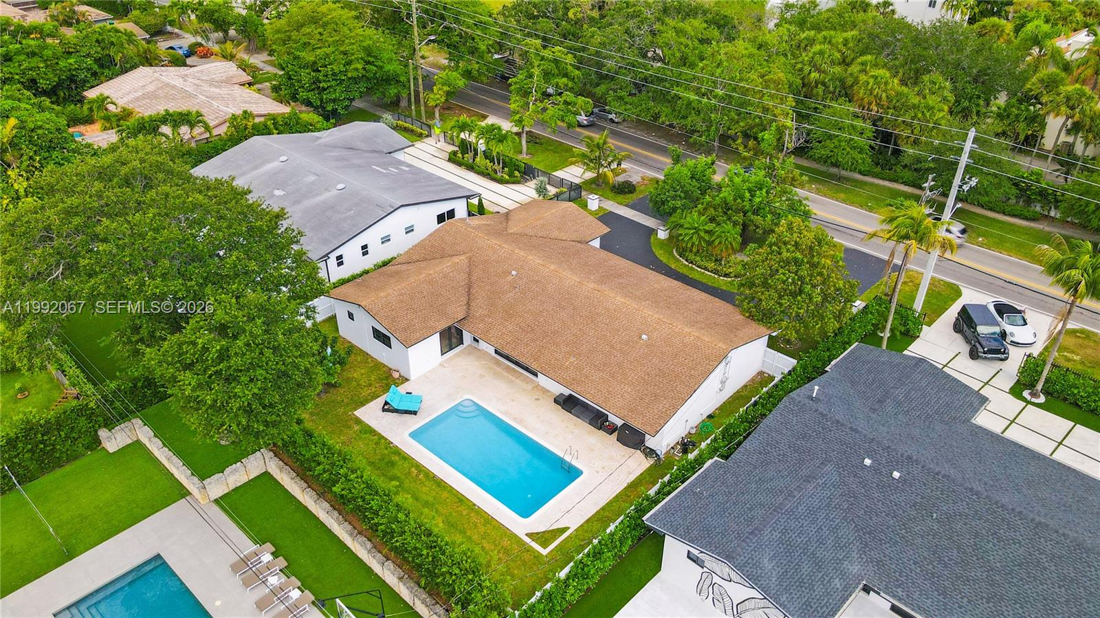 Elegant one-story residence in the prestigious Skylake Manors, offering refined living on an expansive lot. This beautifully appointed 4-bedroom, 3-bathroom home features a seamless layout with spacious living areas, formal dining, and a thoughtfully designed floor plan ideal for both everyday comfort and upscale entertaining.
The gourmet kitchen is equipped with gas appliances and flows effortlessly into the main living spaces, enhanced by natural light and sleek tile flooring throughout. The primary suite provides a private retreat with dual sinks and a separate tub and shower.
Step into your own resort-style backyard, complete with a sparkling pool, lush privacy fencing, and ample space for outdoor entertaining. A circular driveway and 2-car garage add convenience and curb appeal.
Built with durability and sophistication in mind, the home includes impact windows and doors, hurricane shutters, and quality construction throughout. With no HOA restrictions, this property offers both exclusivity and flexibility.
Ideally located near top schools, fine dining, and premier shopping, this is a rare opportunity to own a distinguished home in one of Miami’s most sought-after neighborhoods.