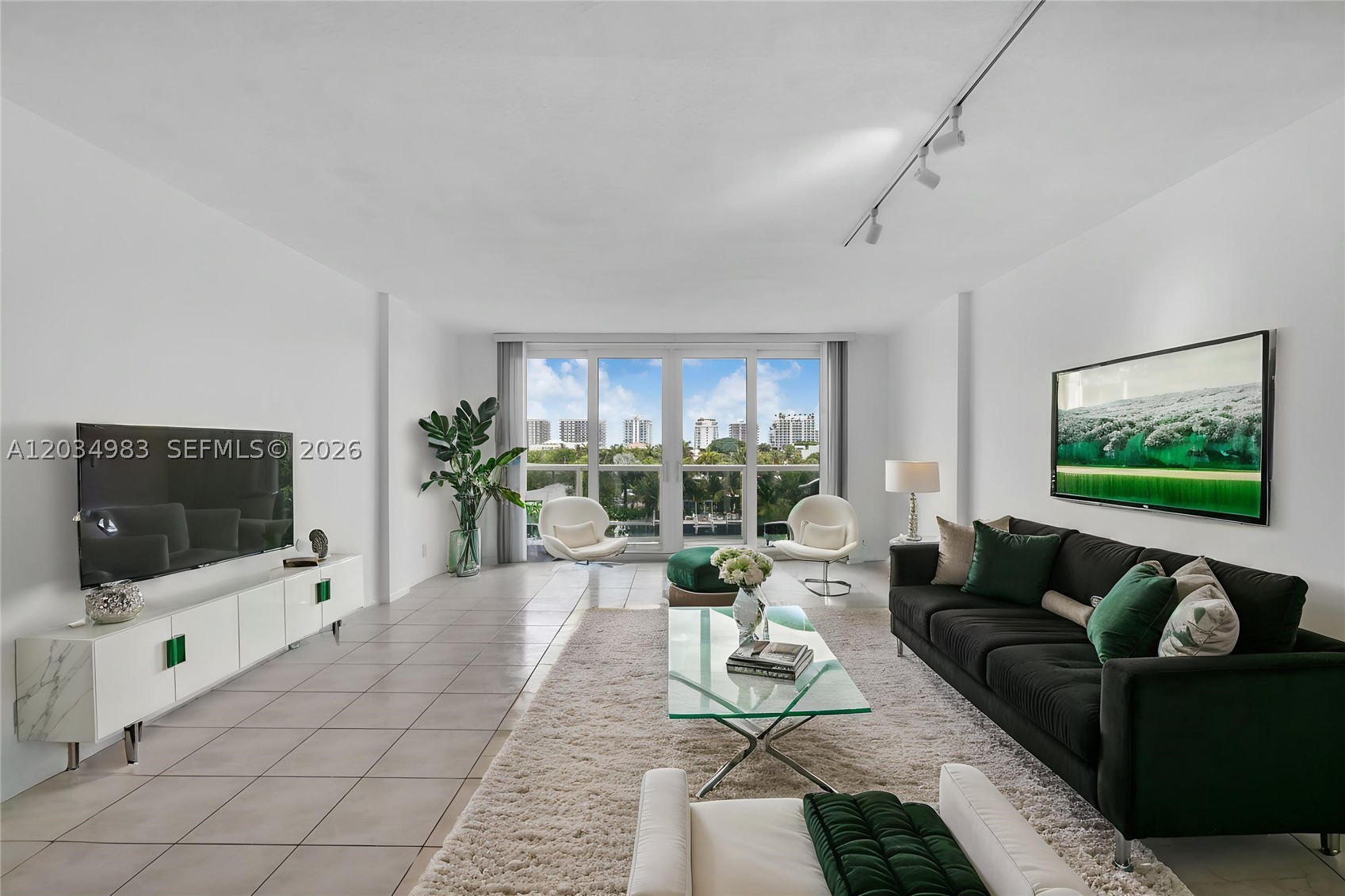 Step into elevated coastal living in this stunning 1 bed / 1.5 bath condo boasting 1,080 SF of beautifully designed space and endless natural light. This elegant condo features high ceilings, tile flooring in the main living areas, warm laminate in the bedroom, and impact windows framing sweeping east-facing views. Unit has been freshly painted throughout to a beautiful white color to enhance the spaciousness of the unit. Kitchen cabinets have been updated along with brand new stainless steel appliances installed. Wake up to unforgettable sunrises and enjoy serene, unobstructed water views from every room. The spacious layout flows effortlessly, complemented by a covered parking space for added convenience. Residents enjoy a waterfront pool, inviting party room, and the peace of mind of a well-maintained building with all recertifications up to date. This is the best priced unit on E. Bay Harbor Drive with a water view. Don't miss out on this great opportunity to own a piece of paradise. Perfectly positioned on the east side of Bay Harbour and just minutes from upscale dining, shopping, and the pristine beaches of Bal Harbour and Surfside. This is luxury coastal living at its finest! **No Leasing during the 1st year of ownership and no more than 20% of the units can be rented**