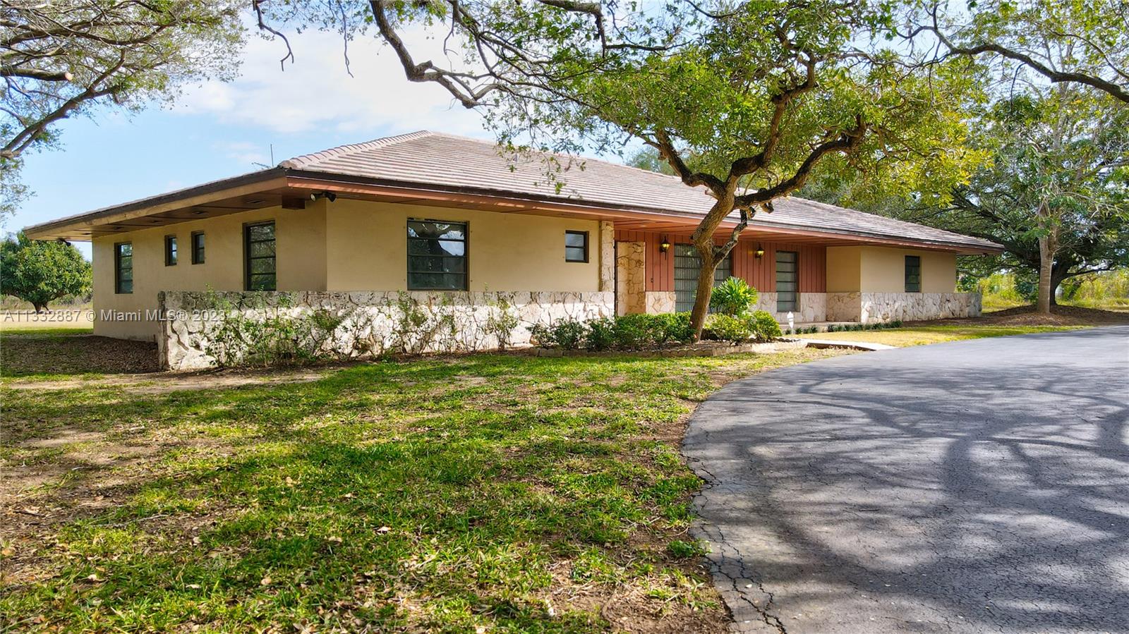 Location, location! Well built CBS home with flat tile roof. Beautiful street presence. Over 3000 sq ft home on over 18 acres. Property has a large detached CBS garage and a second CBS equipment garage. Well Maintained home by one of the original Homesteaders of the area. Located in the Redlands. Excellent location, in desirable residential Redlands north quadrant, and minutes from US-1. Easy in and out, located on the corner of SW 248th St. "Coconut Palm" and SW 157th Av. "Newton". Rare opportunity for home and agricultural business. Large property that can be subdivided and partitioned. Avocado grove gives you income and agricultural status for taxes. The Redlands,  Florida's last frontier, south Florida's last agricultural land area. Located between the Florida Keys  and  greater Miami.