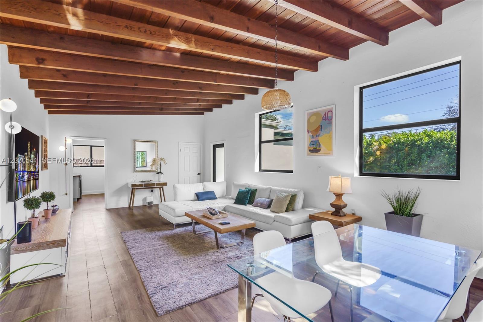 Exceptional mid-century modern home in the heart of Biscayne Park,showcasing dramatic vaulted ceilings,refined architectual lines,& a beautifully curated indoor-outdoor lifestyle.This 3 bd/2ba home features impact doors & windows throughout,bright updated bathrooms,& sun-filled living spaces framed by lush tropical greenery.Expansive grounds offer a private,resort-style setting wth BBQ pavilion,spa,jacuzzi,multiple lounging areas designed for entertaining.Oversized lot room for pool.Fully Airbnb-approved & turnkey.A rare opportunity to own a timeless architectural gem in one of Miami's most coveted neighborhoods.