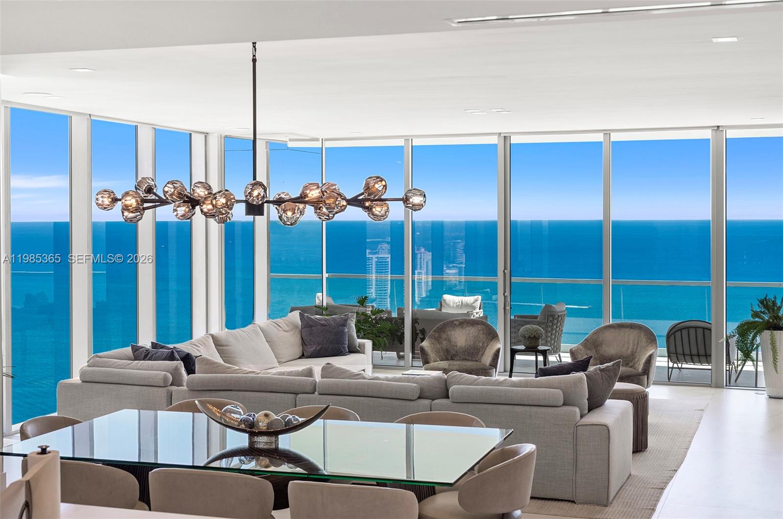Embrace a lifestyle of elegance at Turnberry Ocean Club, where this high-floor corner residence offers unobstructed views of the Atlantic Ocean and Intracoastal Waterway. This exceptional fully-furnished residence features 4 bedrooms, 5.5 bathrooms, and a spacious study. The flow-through floor plan boasts 12-foot ceilings and elegant finishes throughout. The open gourmet kitchen, equipped with sleek cabinetry and high-end appliances, seamlessly flows into multiple living and dining areas, perfect for entertaining. Expansive terraces with a summer kitchen invite outdoor enjoyment, while a private elevator adds convenience. Enjoy exclusive access to world-class amenities, including the iconic Sky Club with pools, private dining, and a wellness spa.