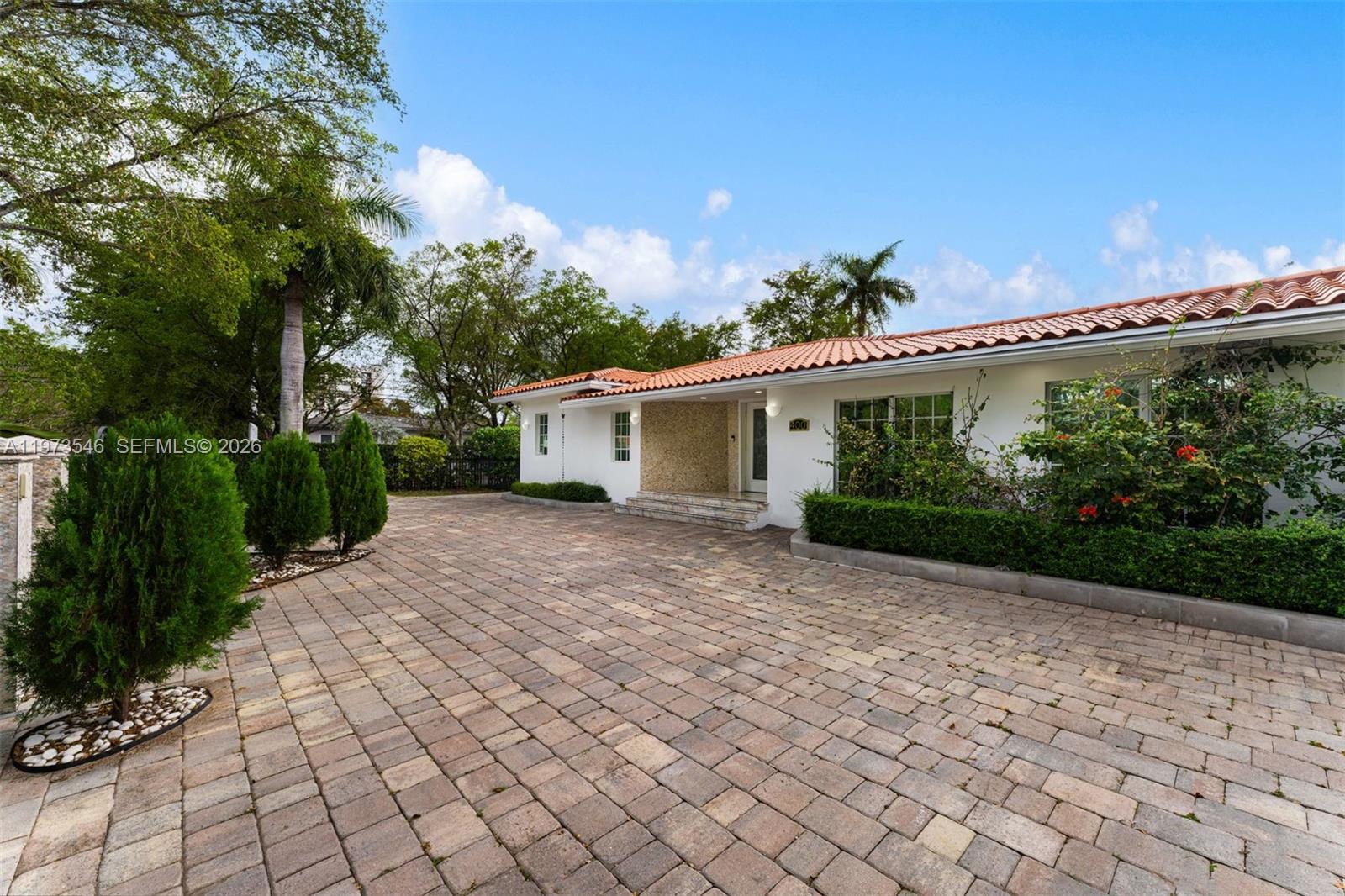 Welcome to 400 SW 24th Road, nestled on a quiet street in one of the most desirable pockets of The Roads. Set on a rare double lot spanning 12,700 SF with nearly 4,000 SF of interior living space, the home offers 4 bedrooms, 4 bathrooms, and additional rooms with the flexibility to accommodate a gym, office, or theater.
Key upgrades include porcelain floors, an updated kitchen with high-end appliances and custom cabinetry, renovated bathrooms, updated electrical, newer AC systems, and a Spanish tile roof. Outdoors, the fully fenced, lush landscape features mature mango, avocado, and lemon trees supported by an irrigation system. An oversized heated pool, covered and open patio areas, and a four-car driveway with Tesla charger round out this exceptional property all just minutes from Brickell, Downtown, and Coconut Grove.