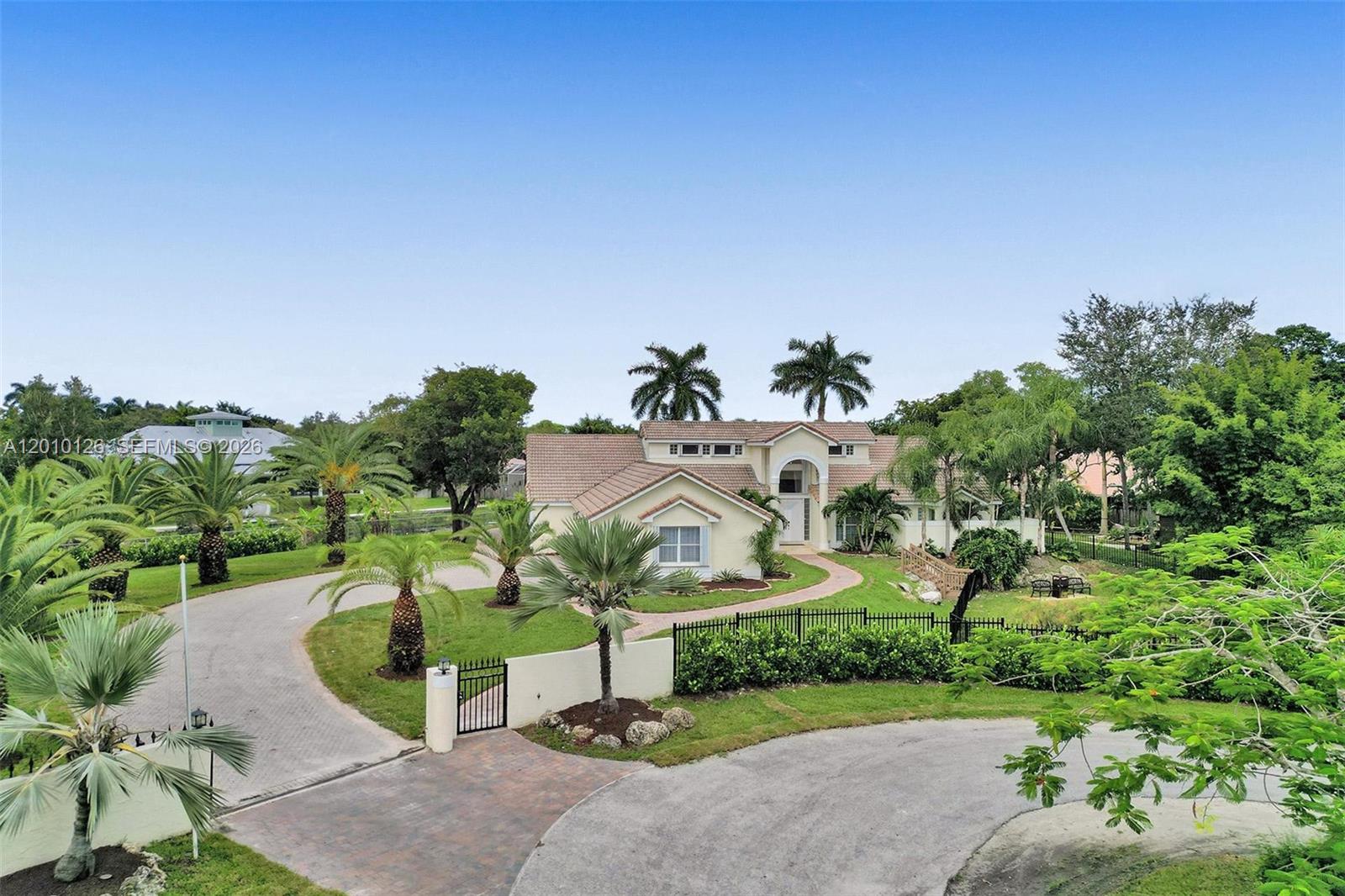 Experience a private resort-style estate designed for exceptional living. This stunning luxury residence blends comfort, elegance, and endless entertainment in a serene setting. The main home showcases 5 spacious bedrooms and 3 full baths, highlighted by soaring ceilings and a light-filled open-concept layout that creates an inviting and sophisticated ambiance.
A separate 3-bedroom, 1-bath guest house offers ideal accommodations for extended family, guests, or additional flexibility. The grounds are equally captivating, featuring a tranquil fishpond with a peaceful seating area—perfect for quiet moments of reflection. Designed with both relaxation and recreation in mind, the property includes a dedicated meditation room, an expansive game room, and extraordinary outdoor amenities. Enjoy a private heated pool, mini-golf course, and a children’s playground, all set within lush surroundings—creating the ultimate backdrop for entertaining, family gatherings, and unforgettable experiences.