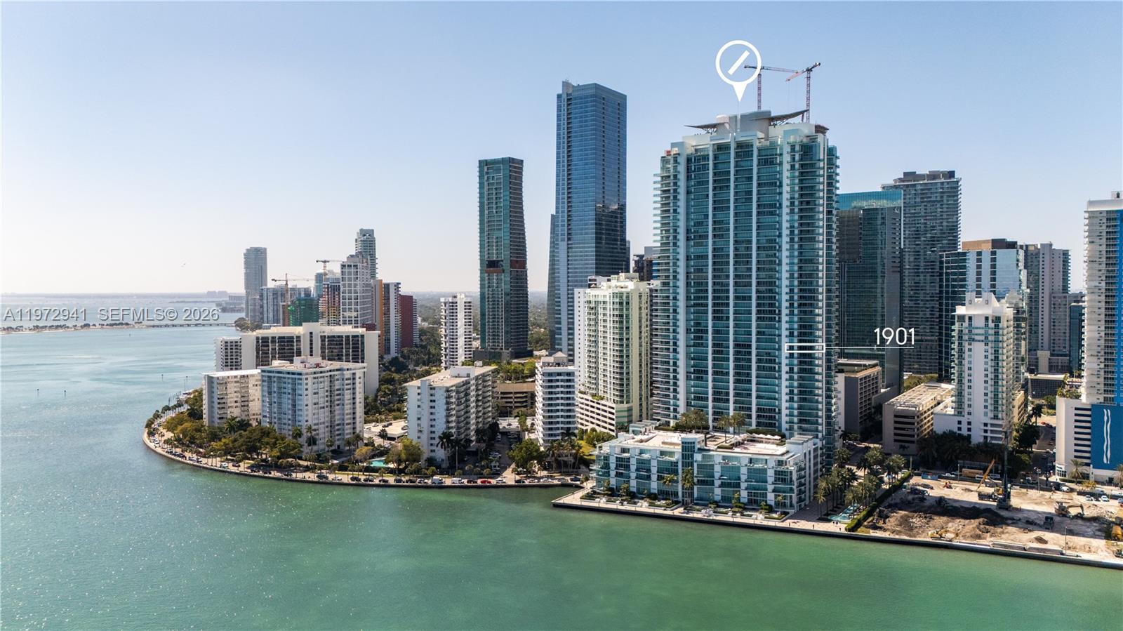 Welcome to Unit 1901 at Jade Residences at Brickell Bay, a NE corner residence in the Brickell Financial District with panoramic views of Biscayne Bay and the Atlantic Ocean. Bathed in natural light, this immaculate home features a private elevator entry and foyer opening to expansive living areas framed by floor-to-ceiling glass. Marble floors throughout, designer wallpaper, custom wood paneling, and electric shades. Oversized covered terrace ideal for sunrise views and entertaining, offering seamless indoor-outdoor living with breathtaking water views from multiple rooms. Includes 2 assigned parking spaces and private storage. Furniture negotiable. Full-service waterfront building in a premier bayfront location near Brickell dining and shopping.