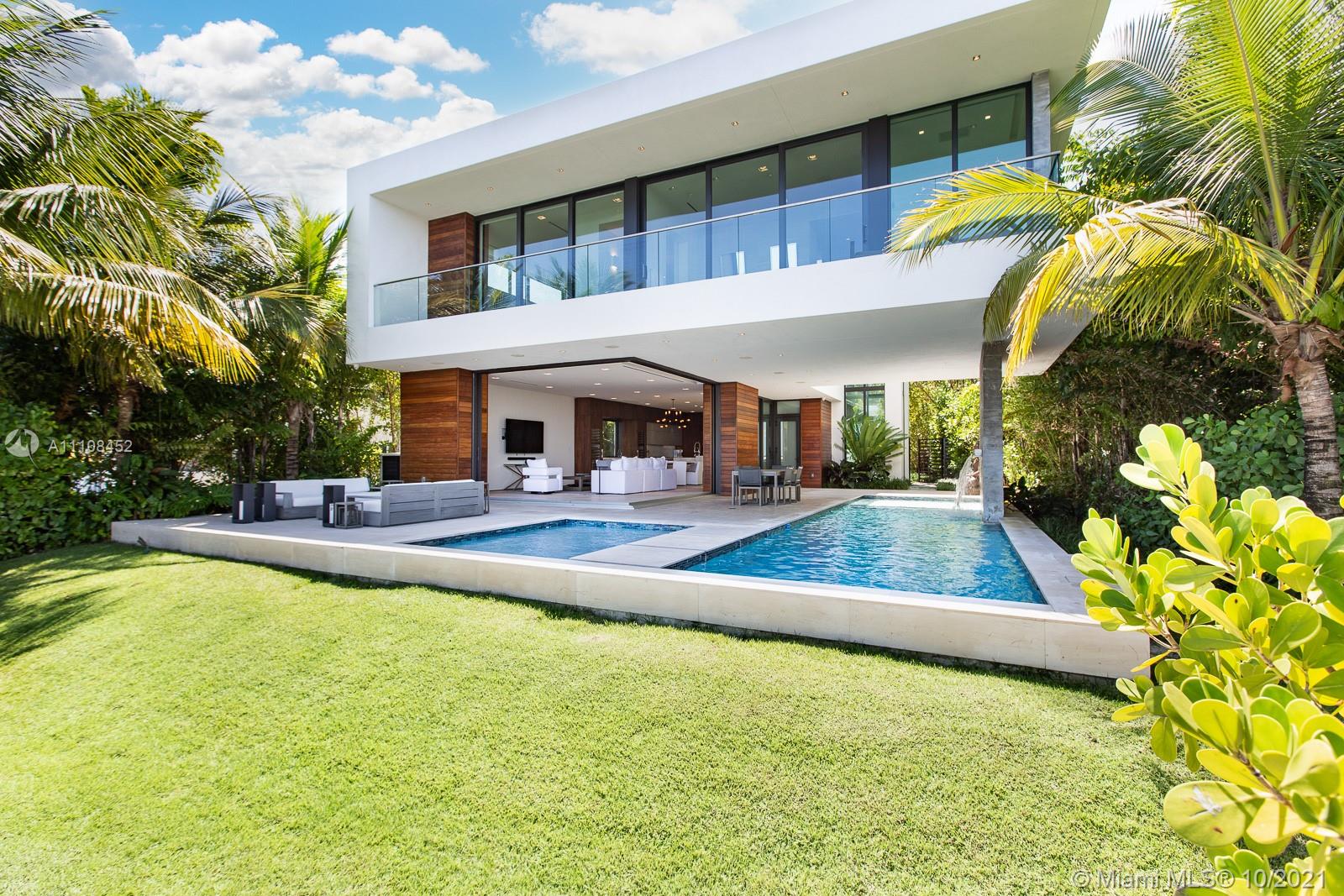 Welcome home to your very own furnished tropical waterfront estate. Located on prestigious Hibiscus Island with a 24/7 guard gate. Your private masterpiece offers wide bay views as well as views of Downtown Miami and Brickell, which provide for breathtaking sunsets. This home was masterfully designed in 2017 by award-winning architect Choeff Levy Fischman. The indoor/outdoor living is perfect for entertaining with its open dining and family areas. Featuring custom Italian kitchen, oak wood floors, brand new state of the art Crestron system, floor to ceiling windows and a 2 car garage. Step outside to your own resort style oasis including a salt water pool and spa as well as your own private dock. This is a must see!