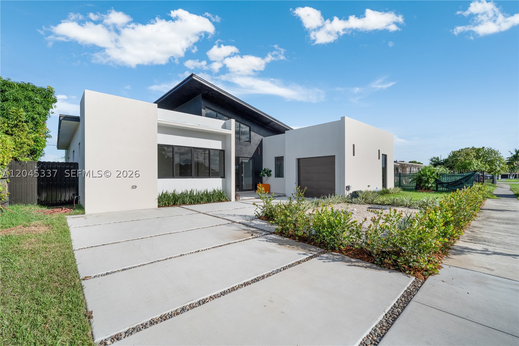 Experience the ultimate in modern luxury with this one-of-a-kind residence, offering
2,600 sq. ft. of living space thoughtfully designed for elegance and comfort. Built with
solid concrete construction, this home combines durability with contemporary style.
Inside, you’ll be greeted by soaring 22-foot ceilings that create a breathtaking sense of
space and sophistication. The home features 4 spacious bedrooms and 3 beautifully
designed bathrooms, perfect for both family living and entertaining guests. Enjoy a
modern gourmet kitchen featuring custom wood cabinetry and a stunning Taj Mahal
Quartz countertop, perfectly blending beauty with durability. The expansive living
areas flow seamlessly into the outdoors, where you’ll find your private terrace with a
sparkling pool, the perfect retreat for relaxation or gatherings. A secure garage adds
convenience and peace of mind. This property is not just a home—it’s a lifestyle. With
its luxurious finishes, unique architectural design, and resort-style amenities, it offers
the perfect blend of comfort, beauty, and exclusivity.