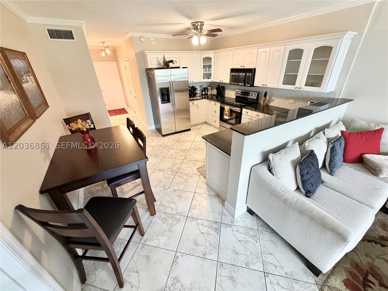 Take a look at the best priced interior corner unit in Rio Nuevo, with garden and water views from your balcony. Inside, you'll find a gourmet kitchen with white shaker cabinets, granite countertops, & stainless steel appliances.Comfortable living areas, including a versatile secondary bedroom with a Murphy bed that serves as the perfect home office or guest room.  Impact Windows & Doors, Extended AC warranty. All offers considered, can be sold furnished as well. The 50-year Inspection is complete w/strong reserves in place. 1 mile to I-95, 2 miles to Las Olas, and only 4 miles to the beach! Rio Nuevo is a gated, waterfront community with covered parking, security cameras, pool, clubhouse & even a community dock for pickups & drop offs. Situated on the second floor with elevator access just steps away, this is the perfect property to call home. Schedule your private showing today!