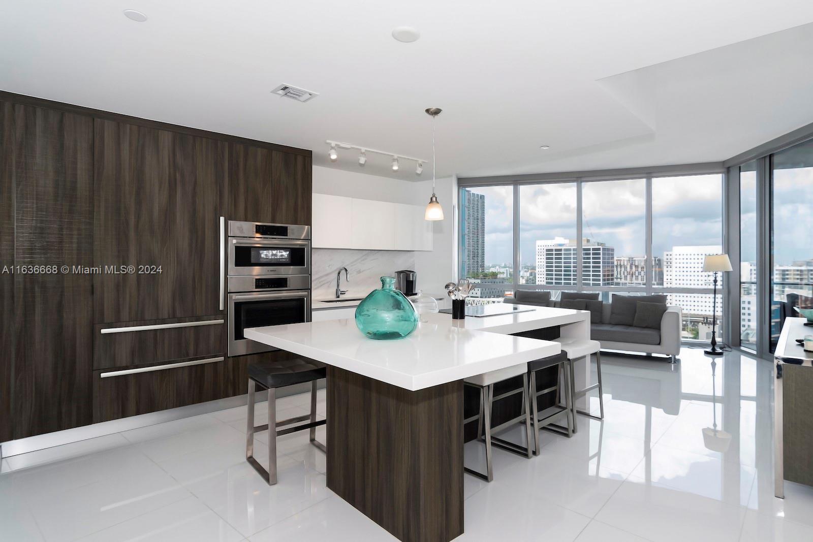Discover opulent living at Paramount Miami Worldcenter. This upscale, furnished 1 Bed + Den, 2 Bath unit offers 10-ft ceilings and a private elevator entry, ensuring both grandeur and privacy. The European Kitchen boasts top-of-the-line appliances. Step onto the spacious balcony for stunning city skyline views, creating an idyllic outdoor living space. Enjoy unmatched condo amenities: 5 pools, Basketball Court, Spa, Gym with boxing area, BBQ Kitchen. Unit is rented for $4,650 until 04/13/2027. Perfect for investors.