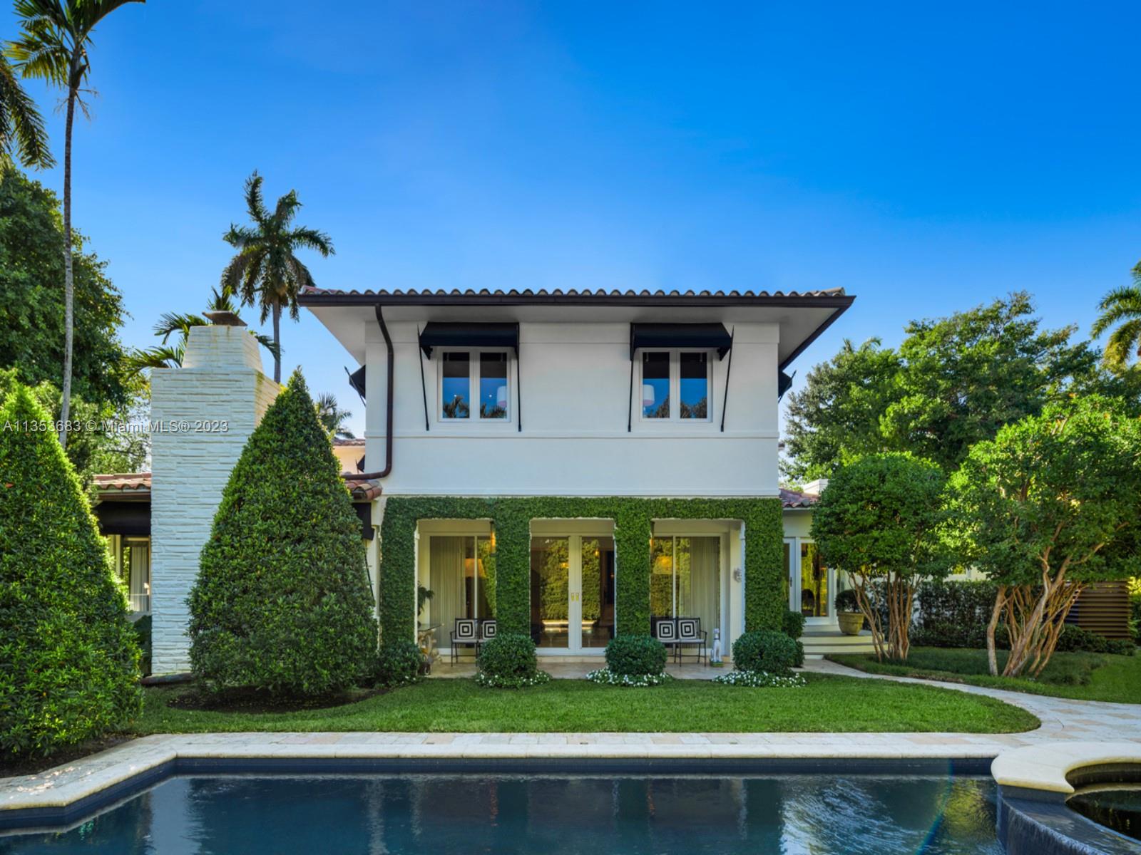 Step Inside With Me! Love on La Gorce Island where 90210 meets 33141. This Art Deco stunner has been completely reconstructed in exquisite taste. Greeted by a glamorous foyer, this Beverly Hill style home flows beautifully. Host in the salon overlooking the pool, unwind in the fireplace room, indulge in the glamorous dining room with curved bay windows, and rest in a designer chic primary suite with natural light from all sides. Entertain in the lush and oversized backyard, soak in the sparkling 30 foot heated pool or recharge in the jacuzzi. The curved driveway welcomes a 2-car garage plus an additional carport making this prime corner lot position one of Miami Beach’s top interior homes. The privacy, streetscape and security of gated La Gorce Island are unmatched.
