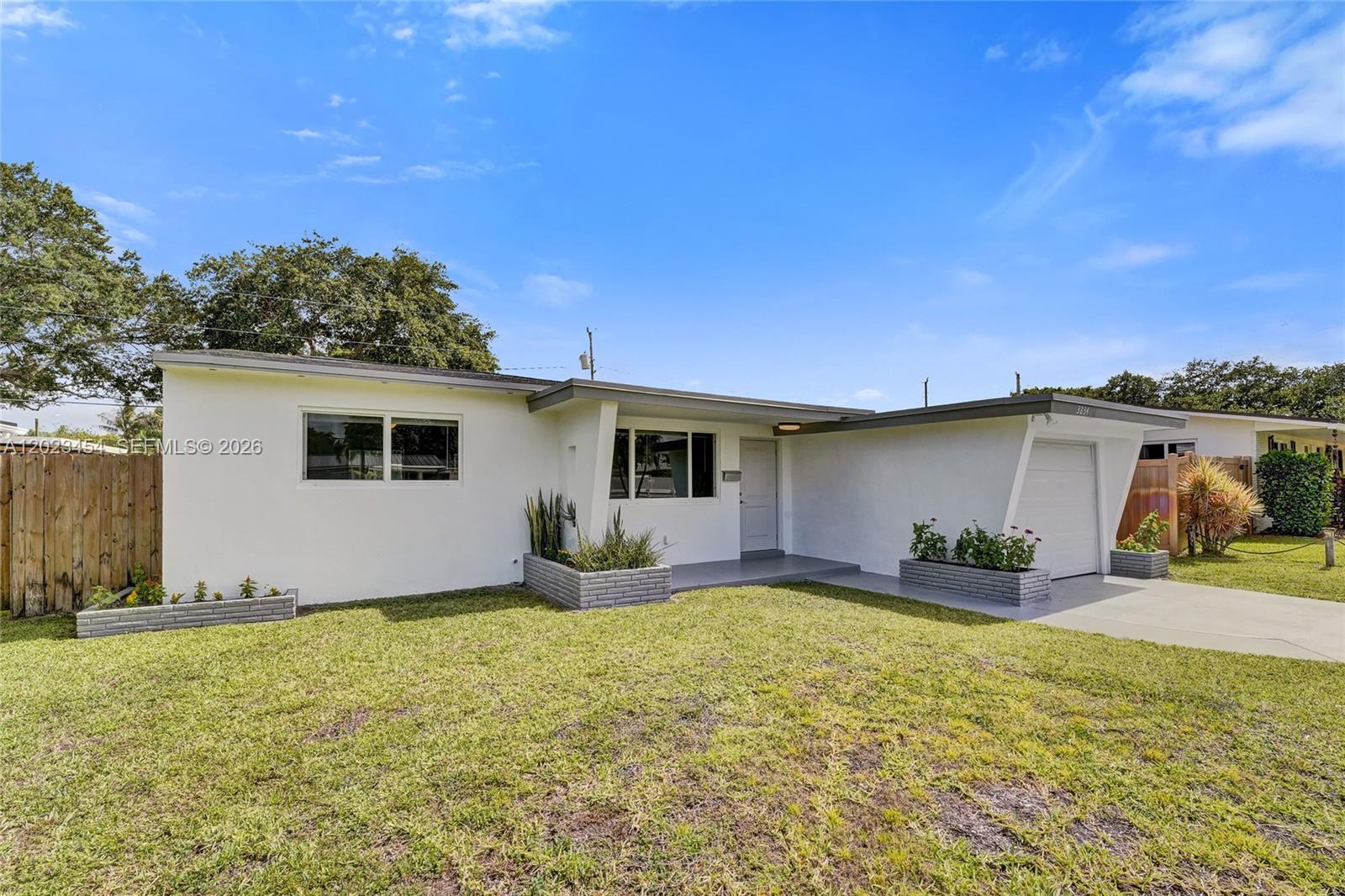 Renovated home in immaculate, move in ready condition. NEW A/C, electrical panel, hurricane impact windows & doors, & a NEWER permitted ROOF, offering peace of mind with the home’s major improvements already completed. Plumbing was updated in 2020, & the home has freshly been painted both interior & exterior. Filled with abundant natural light, the interior offers an airy feel with numerous windows & consistent flooring throughout. Modern renovated bathrooms & a beautifully updated kitchen are complemented by newer stainless steel appliances. Separate laundry room with additional storage space.  A newly installed privacy fence enhances  the large backyard, creating a secluded outdoor setting ideal for entertaining, with ample room for a pool. The spacious lot also accommodate a boats, trailers, or additional vehicles. Ideally located near shopping, dining, entertainment, & everyday conveniences. Just 15 minutes to Hollywood Beach, Seminole Hard Rock Hotel & Casino Hollywood, & The Fort pickleball, & only 10 minutes to Dania Pointe. Grocery stores, Target, & the YMCA of South Florida are all within a mile. Come experience all this home has to offer & make it your own slice of paradise.