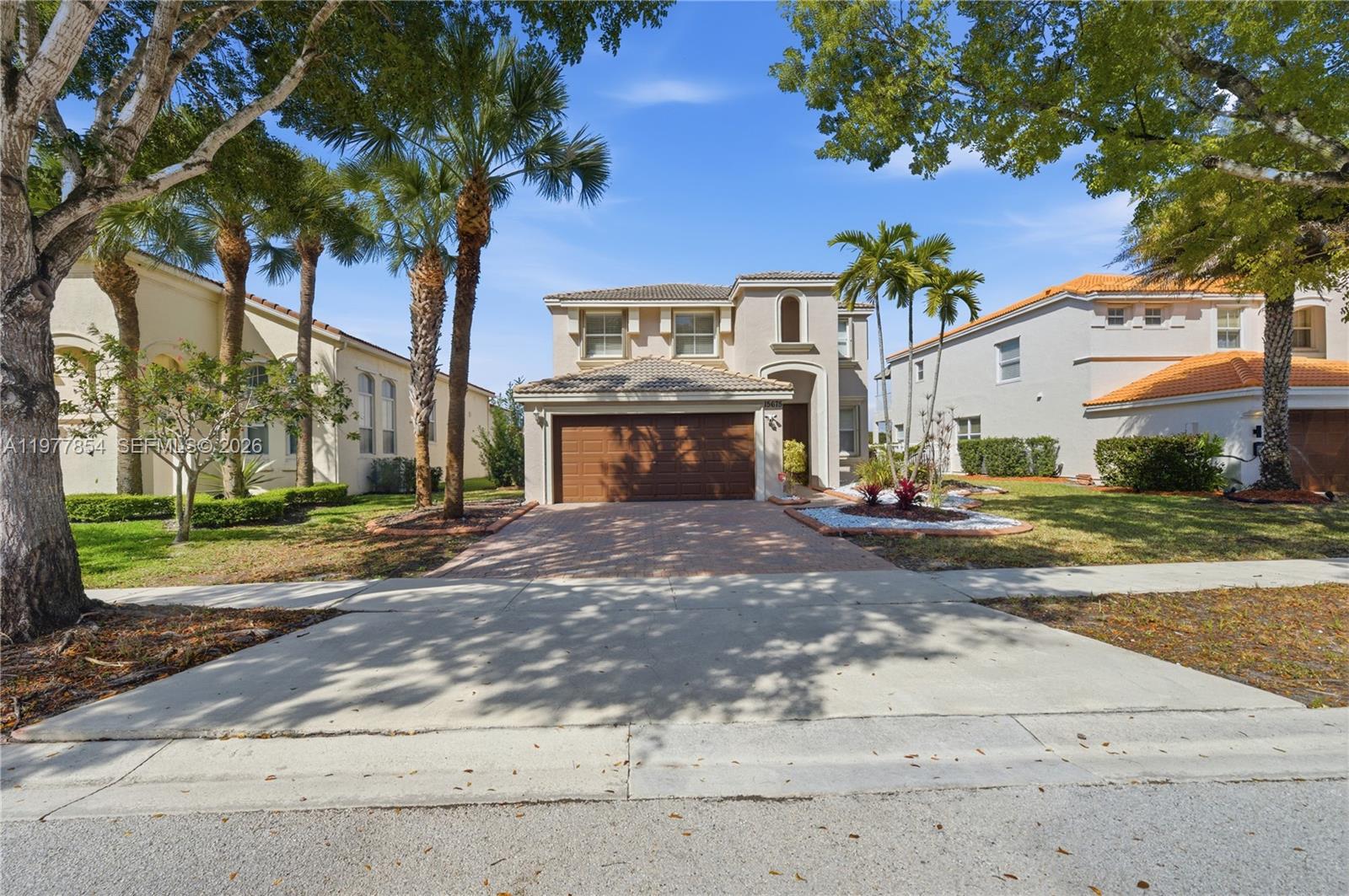 Welcome home to this beautiful LAKEFRONT two-story residence in the prestigious gated Riviera Isles community of West Miramar. From the moment you step inside, stunning lake views greet you & instantly set a peaceful, resort-like tone throughout the home.This spacious home features 4 bedrooms & 3 full bathrooms with tile & wood laminate flooring in the bedrooms. The open kitchen includes granite countertops, center island & walk-in pantry that flows seamlessly into the living & dining areas for everyday living & entertaining. The high ceilings enhance the main living area. The entire home has just been freshly painted, giving it a clean & updated feel and a brand-new roof is scheduled to be installed for the future homeowner, providing added value & peace of mind. A covered patio & fenced backyard offer space suitable for pets, room for a pool, outdoor seating or entertaining while enjoying lake views, visiting duck wildlife & a mango tree. Located within the gated, resort-style community of Riviera Isles, this home is part of a vibrant neighborhood built around a stunning 225-acre lake. Residents enjoy exceptional amenities including a lagoon-inspired resort pool, tennis, pickleball & basketball courts, Lakeview fitness center & multiple playgrounds. The community is family-friendly & conveniently located near shopping, dining & major highways, just across I-75 in Southwest Broward. Convenient move-in ready ready opportunity.