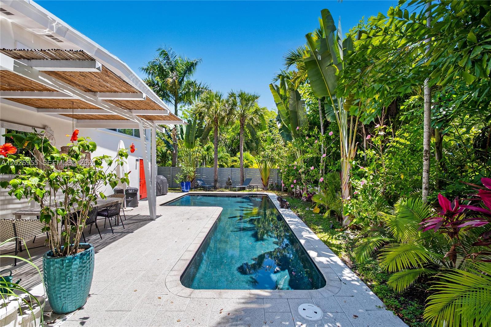 Stunning 3-bedroom Mid-Century Modern residence tucked away on a secluded dead-end street leading to the bay, offering privacy, tranquility, and timeless architectural charm. Surrounded by lush tropical landscaping, this warm and inviting home blends sophistication, comfort, and effortless indoor-outdoor living. Designed with soaring high ceilings and expansive light-filled living spaces, the home offers a cozy and refined ambiance. Thoughtfully updated while preserving its original character, it features elegant finishes, generous entertaining areas, and seamless views of the outdoor surroundings.
Layout offers a separate kids’ area on the main floor, while the expansive primary suite is located on the second floor as a serene retreat with two walk-in closets. An oversized garage has been transformed into a family room. The gourmet kitchen flows into the living and dining areas, ideal for daily living and entertaining. Large glass doors open to a private outdoor oasis with a heated Balinese-style pool, surrounded by lush greenery and multiple lounge areas for relaxation and gatherings.
Combining luxury with sustainability, the property includes 96 solar panels for outstanding energy efficiency. 
Ideally located near the bay on a quiet dead-end street, it offers rare private resort-style living. 
A truly unique offering combining architecture, comfort, and perfect location.