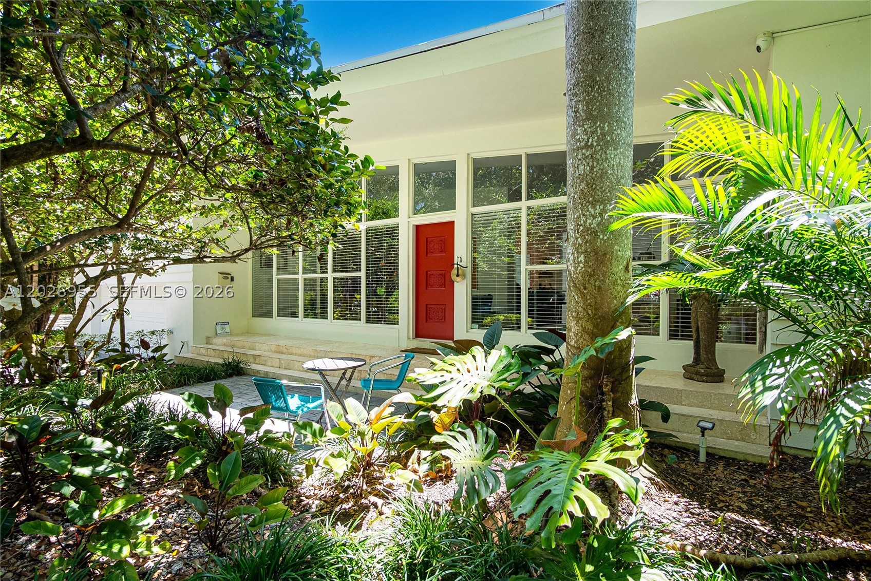 Stunning 3-bedroom Mid-Century Modern residence in a secluded dead-end street leading to the bay, offering privacy, tranquility, and timeless architectural charm. Surrounded by lush tropical landscaping, this warm and inviting home blends sophistication, comfort, and effortless indoor-outdoor living. Designed with high ceilings and expansive light-filled living spaces, the home offers a cozy and refined ambiance. Thoughtfully updated while preserving its original character, the layout offers a separate kids’ area on the main floor, while the expansive primary suite is located on the second floor as a serene retreat with two walk-in closets. Spacious 680 SF double garage currently utilized as a versatile playroom, offering endless possibilities for recreation, storage, a home gym, or future conversion. The gourmet kitchen flows into the living and dining areas, ideal for daily living and entertaining. Large glass doors open to a private outdoor oasis with a heated Balinese-style pool, surrounded by lush greenery and multiple lounge areas for relaxation and gatherings.
Combining luxury with sustainability, the property includes 96 solar panels for outstanding energy efficiency. 
Ideally located near the bay on a quiet dead-end street, it offers rare private resort-style living. 
A truly unique offering combining architecture, comfort, and perfect location.