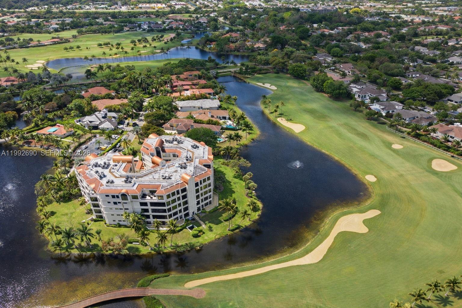 Experience the pinnacle of country club living at The Chateau in Boca Grove. This rarely available 3,845 sq. ft. residence offers breathtaking lake and golf course views from all living areas and the primary suite. The expansive floor plan features three bedrooms—each with a private en-suite bath—plus a versatile separate den.
The Primary Suite serves as a true sanctuary, boasting his-and-her walk-in closets, dual water closets, and a separate shower and soaking tub. An impressive great room, perfect for hosting, seamlessly combines the living and dining areas before flowing into a bright, inviting sunroom. Offering a rare level of exclusivity, this residence is one of only two in the building featuring a magnificent wraparound balcony, providing the ultimate setting for South Florida’s indoor-outdoor lifestyle.