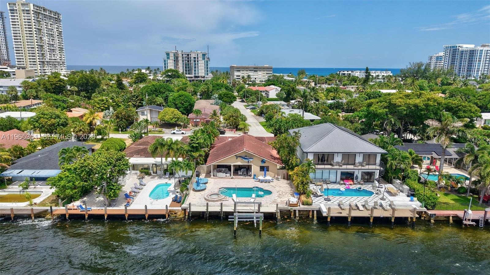 65 feet of prime Intracoastal frontage sets the stage for this luxurious coastal escape, complete with a 17,000-lb boat lift and direct ocean access for spontaneous days at sea. Three private en-suite bedrooms offer intimate luxury, while vaulted ceilings and a designer chef’s kitchen with double ovens ignite unforgettable evenings of entertaining. The open living space spills into a private outdoor oasis—shimmering pool, dockside mornings, and molten sunset views. Just steps from the beach, this residence is pure waterfront temptation—sophisticated, sun-drenched, and effortlessly indulgent.