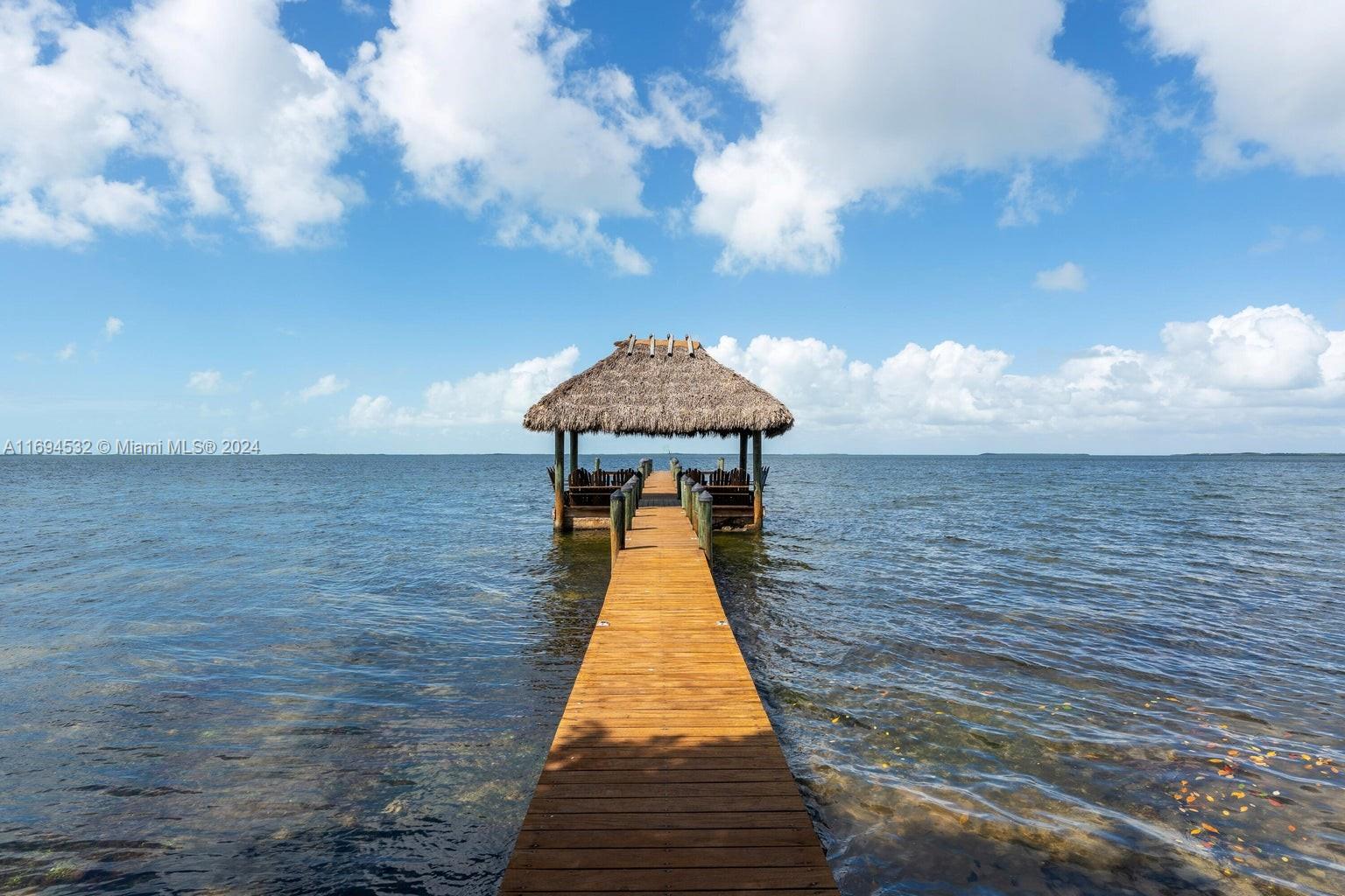 Discover the tranquility of this Bay front condominium with incredible vistas of Florida Bay, including exquisite nightly sunsets! This end unit offers 2 bedrooms and 2.5 bathrooms, a charming open floor plan and comes fully furnished for your convenience. Custom features throughout this charming residence include Florida Keys, keystone wall accents, and a custom mahogany wall unit. The Sanctuary is an exclusive gated community in central Key Largo offering a low density tropical lifestyle with its sprawling 24 acre hardwood hammock, with all the conveniences imaginable in a Keys home.