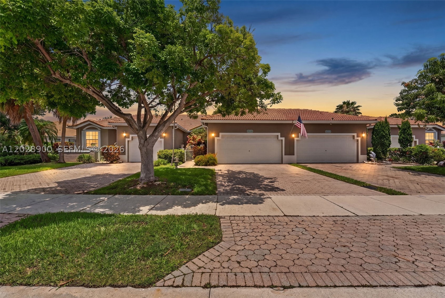 Beautifully renovated, move-in-ready European style villa offering the privacy of a single-family home in a gated community. This stunning residence features a completely re-imagined open-concept floor plan with vaulted ceilings, abundant natural light, and wood look 12 mm 72 hour water resistant, Swiss made laminate.

The showpiece kitchen was fully remodeled with custom floor-to-ceiling cabinetry, a dramatic quartzite stone waterfall island with seating, full-height stone backsplash, recessed lighting, and all-new stainless steel appliances (2023). The spacious living and dining areas flow seamlessly to a covered, screened patio overlooking a peaceful green space with no rear neighbors.

The primary suite features vaulted ceilings, a walk-in closet with built-in organizers, and a spa-inspired bath with dual vessel sinks, soaking tub, and glass-enclosed shower. The remodeled guest bath showcases a floating vanity, quartzite countertop, frameless glass shower, and modern designer finishes.Impactful upgrades and designer finishes make this home truly move-in ready.

Additional highlights include one generously sized secondary bedroom, a dedicated laundry room with LG washer and dryer, oversized 2-car garage, paver driveway, tropical landscaping, and barrel tile roof.

Conveniently located near shopping, dining, schools, parks, and major highways. A rare opportunity to own a fully upgraded, turnkey home in one of Sunrise's most desirable locations.
