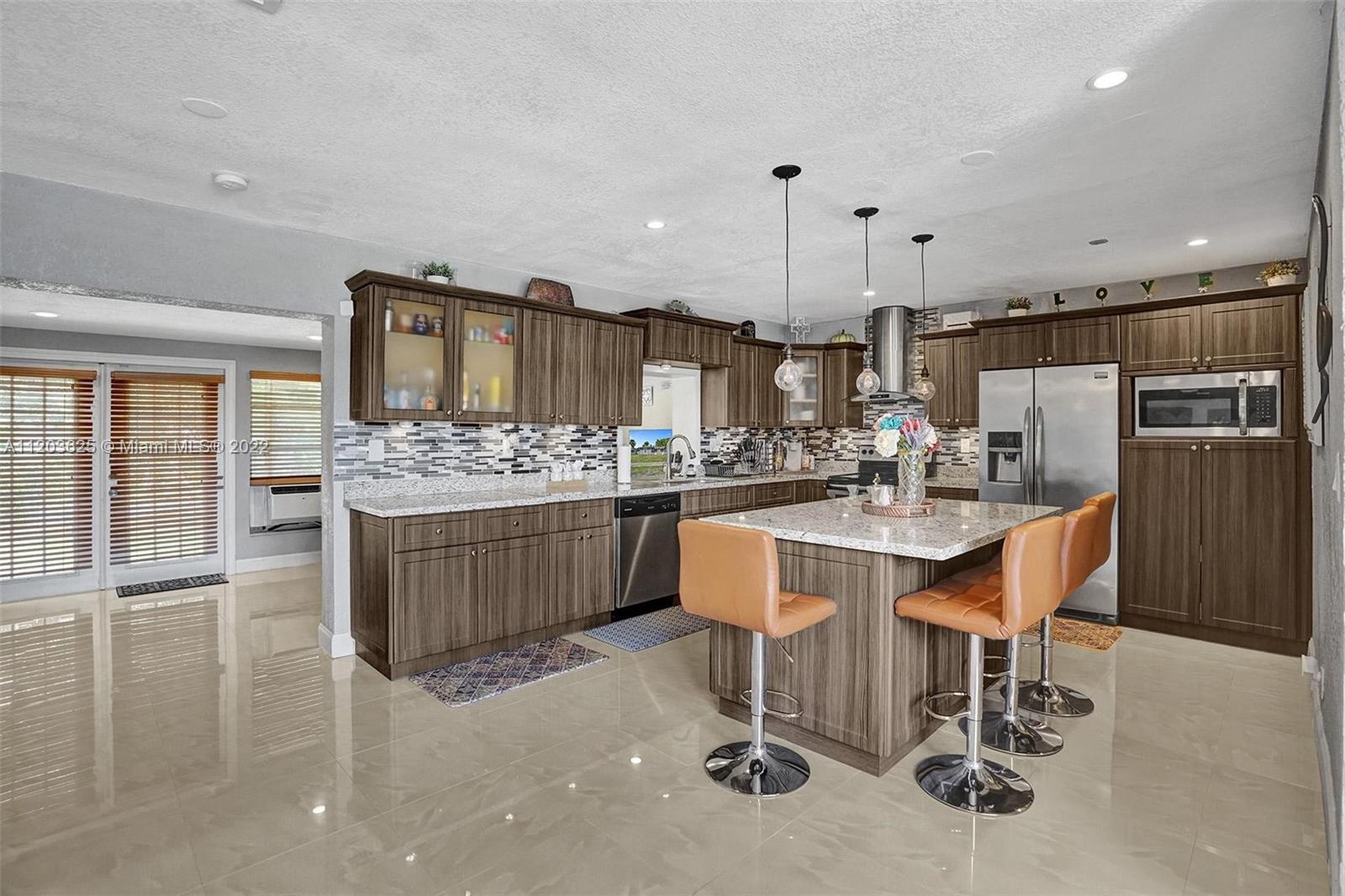 Welcome to this Newly Listed Substantially Upgraded spacious Home, Located Right Off the Florida Turnpike, this 4BED/2BATH features ample size for all your family needs. An Extra-Large Living Room with Additional BONUS Room towards the rear. An amazing upgraded Eat-In Kitchen that boast Granite Counter Tops, Stainless Steel Appliances, and Wood Cabinets. Beautiful porcelain tiles Throughout the house Split-Floor Plan, A spacious Master-bedroom, outside you have enough space for entertainment, beautiful porcelain tiles throughout the house. New roof.  This home is a must see very clean, shows very well. Easy to show and move-in ready.