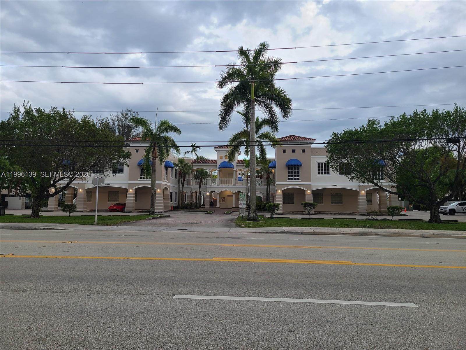 Welcome to Kendall-Tamiami's Premier Penthouse Office space. Located on the main artery connector to 874 Don Shula, Turnpike & Miami Executive Airport. Original owner with no expense spared in design and layout. This Office space presents itself as the nicest in the entire complex with regards to placement, views and layout. As you arrive to your office, access your entrance via staircase or Elevator. The walkway towards the Office is open and welcomes a beautiful lake view. As you enter your spacious marble floor adorned waiting area, you will notice a reception window and secured privacy entry way. Once inside you will notice freshly polished Crema Marfil Marble floors, a long hallway leading to 6 glass enclosed office spaces plus a large conference room w/ balcony & open lake views purposely designed such that every office space provides stunning lake and sunset views. Loft style volume ceilings soaring 11-17’ high throughout. Custom Bruck & Sistemalux lighting throughout. Kitchen area w/ sink & refrigerator. The large 2.2k sqft space features a full Marble bathroom w/ custom glass enclosed Grohe massage jetted shower and a second marble floor to ceiling half bathroom. Security, lights, HVAC & High end sound system throughout all controlled by a Smart Crestron Automation system. Hurricane impact windows and doors. Prime picked 7 deeded parking spaces (2 Covered). Brand new Roof in 2024. HOA completely renovated complex ($750k). Assessment fully paid. Priced to sell fast.