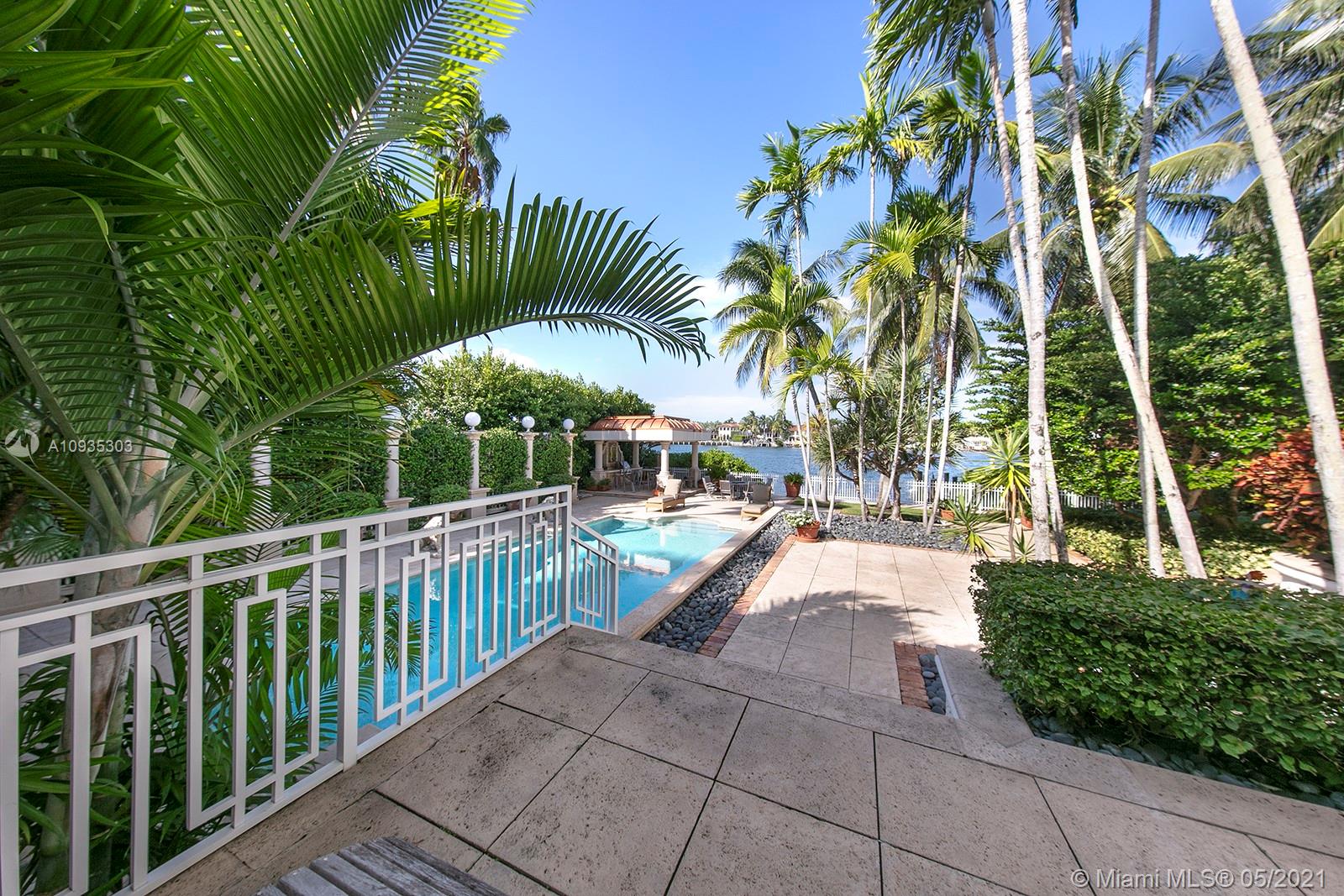 Live in paradise in this mediterranean-inspired waterfront estate located in exclusive community on Palm Island! Architecturally designed w/ large windows providing natural lighting, this 5 BD/4.2 BA home has open floor plan w/ spacious indoor living & covered outdoor living areas, surrounded by beautiful lush landscaping. 100FT of water frontage. Features include a dramatic foyer w/ soaring high ceilings, a grand living room w/ fireplace & 1800’s chandeliers, dining & breakfast spaces, unique cow-bone kitchen cabinets imported from Colombia, Oak Wood floors, an African Rosewood Media Room, a corner office, a bar w/ built-in aquarium, a master suite w/ 2 balconies, & more! Enjoy stunning views from a comfortable terrace, relax inside pool surrounded by lion-shaped fountains, & private dock
