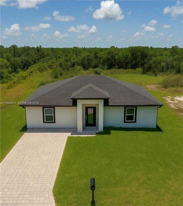 816 Palomino new construction in Lehigh Acres is ready for immediate move-in. This is a brand-new home with clean finishes, a practical layout, and features that buyers actually look for. The home offers 3 bedrooms and 2 bathrooms with 1,500 square feet under air, plus an attached full guest suite that works well for extended family, visitors, or rental use. The layout feels open and bright, with a split-bedroom design that gives privacy where it matters. The attached mother-in-law suite is a private, self-contained space with its own kitchenette. It includes white shaker cabinets, quartz countertops, a stainless steel sink, a mid-size refrigerator, and a built-in microwave. The space is finished with large tile flooring, neutral tones, and a ceiling fan with lighting, making it comfortable and easy to use as a separate living area. The kitchen is finished with stainless steel appliances, real wood cabinets, and quartz countertops. Both bathrooms have a clean, modern look. You also get a tankless water heater, along with an indoor laundry and utility room with washer and dryer hookups. The home includes impact windows and doors, a 2X-wide finished paver driveway, and a large lot with enough space to add a pool. There is no HOA and no restrictions, giving you flexibility to live in it, rent it, or hold it as an investment.
The home is ready to show now. Schedule your tour today.
