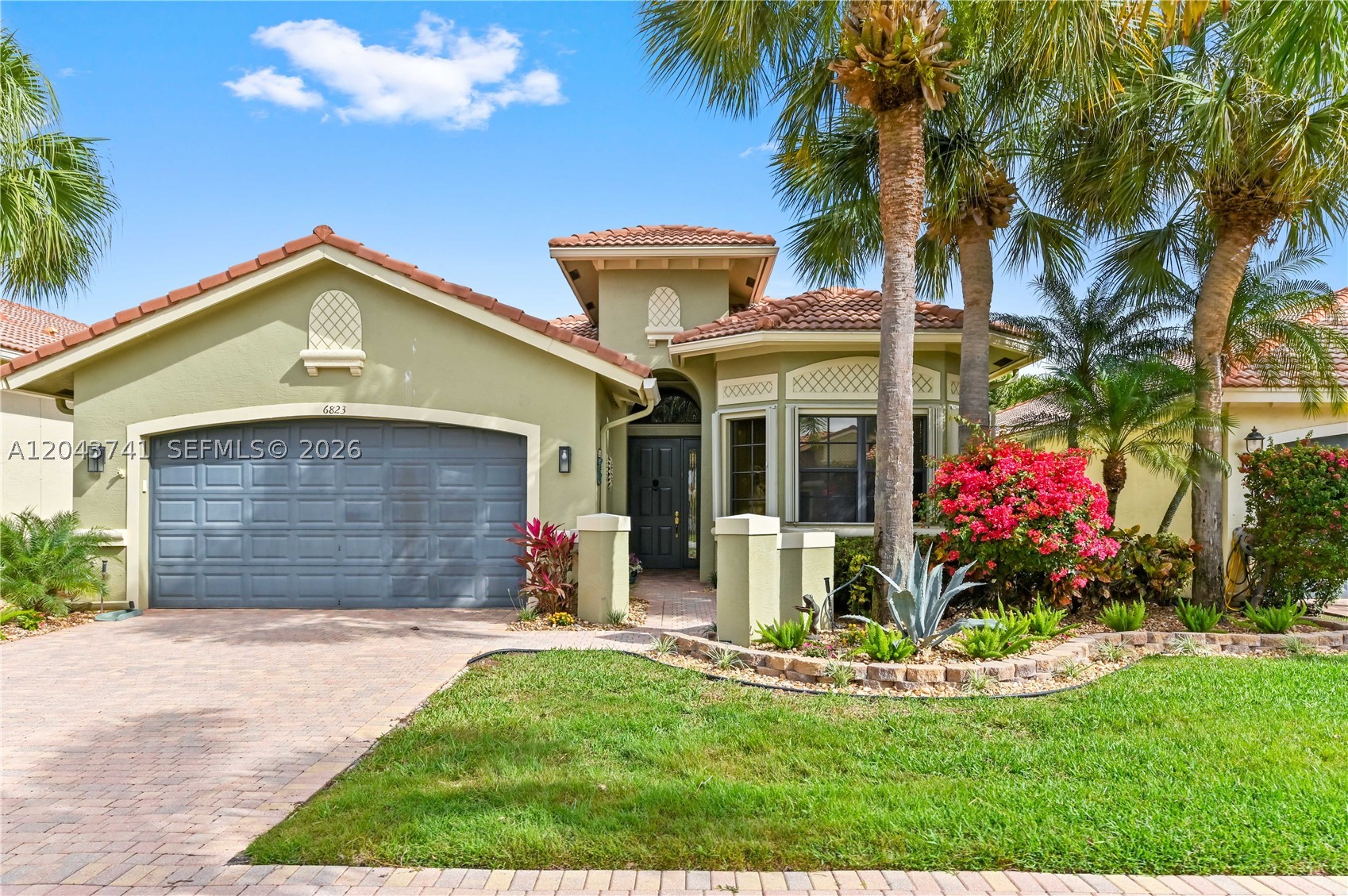 Stunning, spacious (1,919 sf) move-in ready 3/2 with covered private patio overlooking the lake is now available at Tivoli Lakes -- 55+ gated community off of Boynton Beach Blvd. Our luxurious Grigio model features a split-bed layout, high ceilings, crown molding, ceiling fans, tile floors & accordion shutters throughout. Foyer leads to huge living area with access to patio, lake & backyard. Oversized lake-facing breakfast nook complements big kitchen with granite countertops, quality wood cabinets & pantry. Primary bed boasts dark wood porcelain tiles, 2 walk-in closets, ensuite bath with his & her's sinks, corner tub & shower. Enjoy bright natural light, manicured landscaping, laundry room, 2-car garage. Amenities: pool, spa, tennis, gym, pickleball & tons of social activities & clubs!
