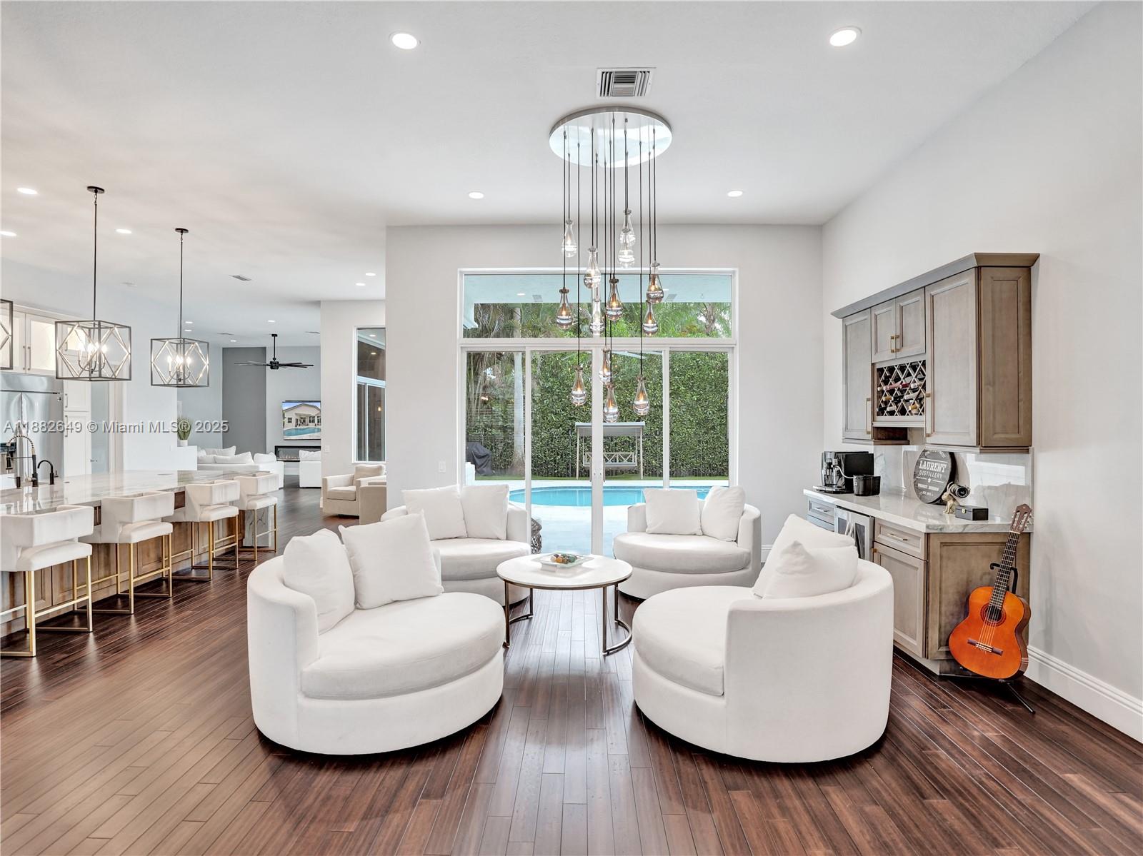 Exquisite 5BD/4.5BA/3CG nestled on a generous 10,000 sqft corner lot in the exclusive enclave of WHCC. Updated open floor plan includes showpiece remodeled gourmet kitchen at the heart of the home w/ huge quartzite island/countertops, high end appliances + eat in nook, custom dry bar w/ wine fridge, Cali Bamboo & Eucalyptus floors, modernized bathrooms, flush LED lighting, electric fireplace + smart electric shades in fam room, 20K designer chandelier in liv room. Additional updates incl new AC (2025), 2nd unit (2022), hybrid water heater (2024), Aug 2019 roof. Heated saltwater pool w/ marble tile deck, pool heater (2025), variable-speed pump (2024). Smart tech includes security cameras, EV charger, and app-controlled shades. Exterior freshly painted (2025). Move-in ready luxury!