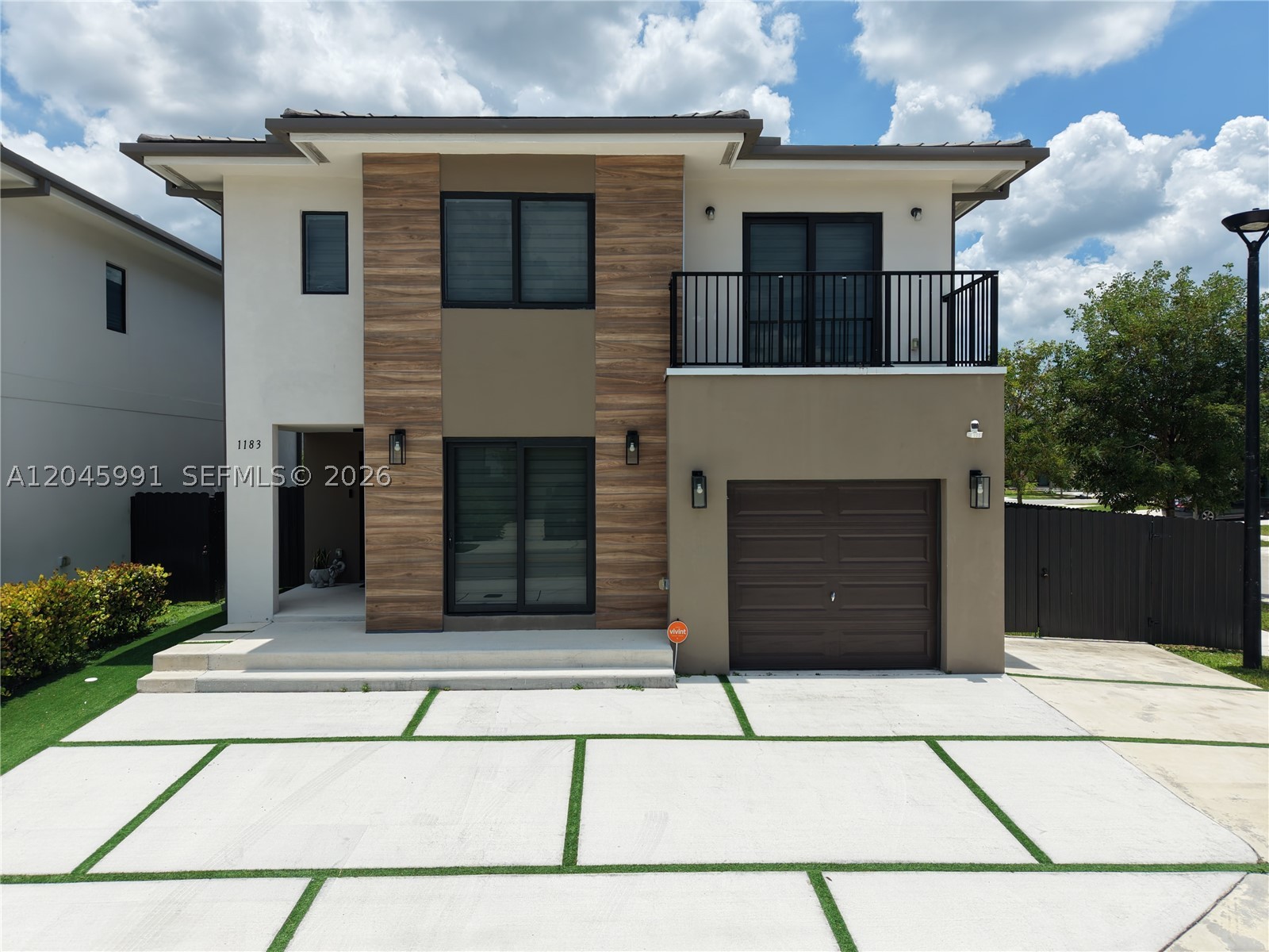 Beautiful newer construction 5-bedroom, 4.5-bathroom home situated on a desirable corner lot just minutes from the Florida Turnpike. This move-in-ready residence features modern finishes, a spacious open layout, and numerous thoughtful upgrades throughout. The primary suite includes a custom walk-in closet, while the balcony has been professionally leveled and finished with non-slip tile for added style and safety. Additional improvements include a whole-house water conditioning system, high-end security system, an expanded driveway providing extra parking, and a fully fenced yard offering privacy and functionality. Very low HOA. Conveniently located near major highways, shopping, dining, schools, and parks, this home combines modern living with exceptional convenience. A must-see!