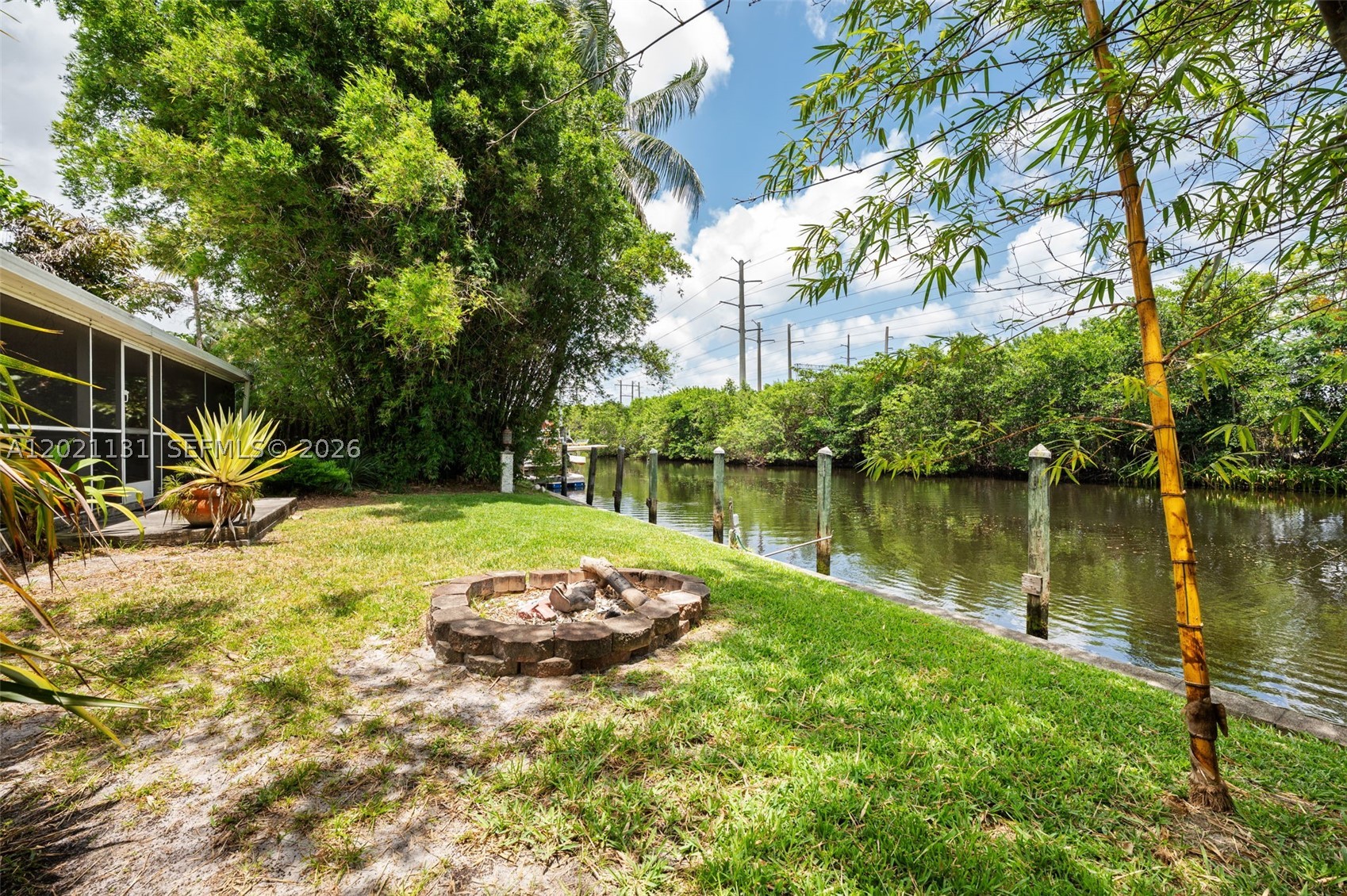 Rare opportunity in desirable Davis Isles! Waterfront 4BD/3BA single-family home featuring 2 primary suites, ideal for extended family or guests. Expanded living room and primary suite additions provide added living space and flexibility. Renovated bathrooms, updated drywall, city water/sewer, and no HOA! Situated on an oversized lot with room for a pool plus space to park a boat or RV. Property backs to a black olive plant nursery offering exceptional privacy with no rear neighbors.

A standout feature is the private boat ramp on the side of the property, plus approx. 75–80 ft of seawall with ocean access and fixed bridges. Additional exterior structures include a boathouse and storage shed for ample storage.

Features include accordion hurricane shutters, EV charger, updated electrical panel (15 yrs), tankless water heater for kitchen/guest baths, separate water heater for primary suite, and A/C replaced within the last 10 yrs. Main roof is original and approx. 30 yrs old; flat roofs added approx. 11 yrs ago. No well or septic.

Minutes to Hollywood Beach, FLL Airport & Hard Rock. Rare opportunity for investors, boaters, Airbnb potential, or buyers seeking a private waterfront lifestyle with endless possibilities. A true boater’s dream offering privacy, flexibility, and rare waterfront features!  Contact Listing agents for private showing!!