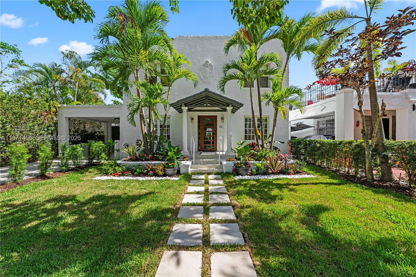 In the heart of Buena Vista, this fully remodeled two-story residence seamlessly blends timeless 1920s charm with sophisticated modern living. The main house boasts four spacious bedrooms and three and a half bathrooms, thoughtfully redesigned with high-end finishes throughout. White oak hardwood floors flow seamlessly across the home, complemented by custom Taj Mahal stone vanities in each bathroom. The renovated kitchen features premium stainless steel appliances and opens to expansive living areas, anchored by a charming fireplace that creates a warm yet refined atmosphere. New hurricane-impact windows and doors flood the home with abundant natural light, enhance energy efficiency, and provide peace of mind. A detached ADU, perfect for guests, rental income, or a private office, offers a studio layout, kitchenette, and full bathroom. Situated on one of Buena Vista’s most desirable tree-lined streets, the home also features a rare enclosed front porch and a private backyard oasis with a brand-new pool currently being installed. Additional features include generous parking, a garage, and a dedicated laundry room. This move-in-ready opportunity is located in one of Miami’s most vibrant and centrally located neighborhoods, just minutes from the Miami Design District’s shops, galleries, and dining.