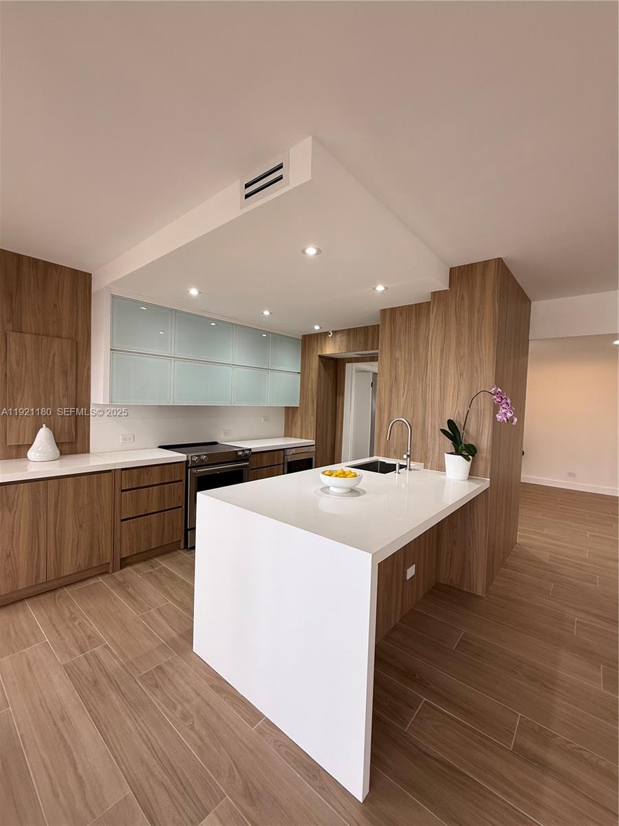STUNNING completely remodeled, open concept. Modern & bright 2/2 split bedroom with floor to ceiling sliding doors and windows in every room leading to a huge wraparound terrace with Intracoastal view. Access to the balcony from every room. Abundant natural light! New porcelain tile floors throughout. Huge master bathroom with double vessel sinks. Freestanding
bathtub and separate shower. Custom cabinets and wall paneling. Quartz countertops & backsplash. High end appliances. New custom closets throughout! New washer/ dryer and A/C. Electric power hurricane shutters with new motors. NEVER OCCUPIED SINCE RENOVATION, A TRUE TURN KEY, MODERN UNIT!!! Building renovated. Enjoy "TERRACES LIFESTYLE" in an elegant 5 star building with resort style amenities! Guard gate, 24 hour security & valet, heated pool and spa, towel service, indoor and outdoor cafe's, 2 fitness centers with sauna, tennis courts, pilates classes, racquetball... Situated on Intercoastal Waterway across from Turnberrys World Class Golf course surrounded by a 3.5 Mile jogging Exercise trail. Walking distance to restaurants, shopping, Aventura Mall, Gulfstream & beaches. Vacant, easy to show.  “SELLER PAID 30k ASSESSMENT FOR RESERVES AND TO COMPLETE 40 YEAR CERTIFICATION “