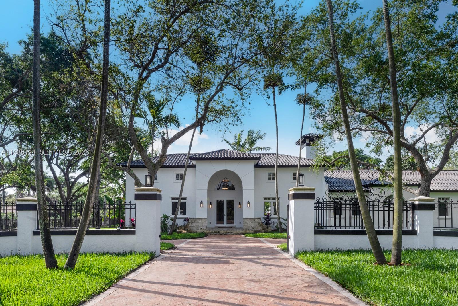 Welcome to your private oasis nestled on a coveted builder’s acre corner lot in the heart of Pinecrest. This gated Mediterranean-style estate offers 6,000 square feet of refined living with 6 bedrooms, 6.5 bathrooms, all on 1 level for maximum convenience. Soaring vaulted ceilings and abundant natural light create an effortlessly elegant atmosphere throughout. Step outside to discover mature oak trees, a sparkling pool and hot tub, and expansive outdoor entertaining spaces that feel like a personal resort. A three-car garage and private tree-lined entrance complete the picture. Minutes from top rated schools, pristine beaches, marinas, & premier shopping , this is South Florida living at its finest.