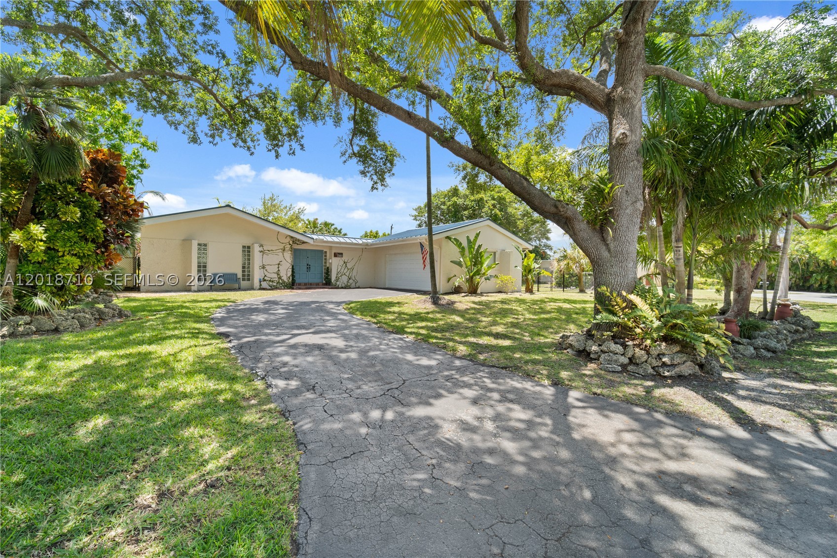 Experience refined living in this exceptional residence in Cutler Bay, gracefully positioned near a quiet cul-de-sac on an impressive 17,160-square-foot lot. Thoughtfully curated with sophisticated finishes and timeless design elements, this home offers an unparalleled blend of comfort and elegance.
The heart of the home is a beautifully appointed chef’s kitchen featuring quartz countertops, premium stainless steel appliances, and seamless flow into the expansive living spaces. Dramatic wood-beam ceilings soar above the main living area, while designer lighting and a well-conceived floor plan create an atmosphere that is both inviting and elevated.
Step outside into your own private oasis, where lush tropical landscaping surrounds a sparkling pool designed for effortless entertaining and serene outdoor living. Recent enhancements include a sleek aluminum roof installed approximately three years ago, as well as imported Chicago brick detailing that adds character and distinction to both the front and rear exterior spaces. Ideally located near Palmer Trinity School and moments from Old Cutler Road, this remarkable property offers convenience, prestige, and privacy — all without the constraints of a homeowner’s association. A rare offering that captures the essence of South Florida luxury living. Private showings available by appointment.