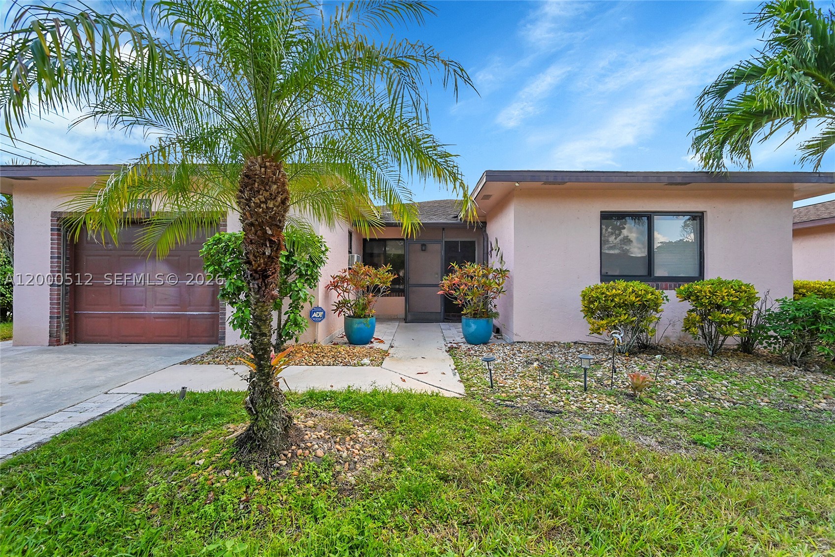 Seller Very Motivated! Rarely available unattached single-family in 55+ community, this fully renovated 3-bedroom, 2-bath + AC Florida room,  offers modern luxury and effortless living. Completely rebuilt, the home features new A/C, new bathrooms, deluxe porcelain flooring, a decorative stone accent wall, custom closets, and motorized blinds. Equipped with full impact windows—noticeably reduces exterior noise while offering prime accessibility The bright, open layout includes a cozy breakfast nook and an air-conditioned Florida room perfect for year-round living or entertaining, all overlooking a tranquil garden view. One bedroom is customized for hobbies, crafts, or a game room. Additional highlights include all impact windows and doors, including a premium sliding glass door, an oversized 1-car garage with A/C, and a whole-house water filtration and purification system.
. HOA covers roof, cable, lawn care, trash, pest control, common areas, exterior building maintenance, roof maintenance, rec. facility and commons areas.Move-in ready and designed for comfort in a well-maintained, active community.