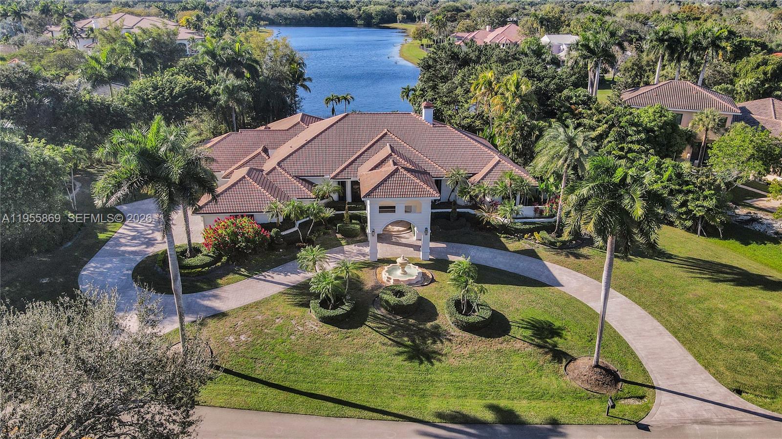 SPECTACULAR LAKEFRONT ESTATE located in the prestigious, guard-gated community of Windmill Ranch Estates, offering BREATHTAKING PANORAMIC LAKE VIEWS AND UNFORGETTABLE SUNSETS! Situated on a premier 1.41 ACRE lot with grand circular driveway, fountain, and porte-cochère entrance. This residence features 5 generously sized bedrooms, 5 bathrooms, office/den, PLUS a private cabana/guest house with full bath. Exquisitely upgraded home featuring custom finishes throughout, new AC systems, elegant built-in wine refrigerator cabinetry, and remodeled bathrooms with spa-style design. Designer statement chandeliers illuminate the interiors, complemented by all LED interior ceiling and exterior landscaping lighting for a sophisticated modern ambiance. Marble floors through-out and floor-to-ceiling windows highlight the expansive living areas complete with fireplace and wet bar. Chef’s kitchen boasts a center island, gas stove, and top-of-the-line appliances. Resort-style outdoor living ideal for entertaining with an oversized re-tiled pool with spa and sunken seating area, summer kitchen, extensive patios, and large fenced-in yard. In addition, Smart Home controlled lighting, pool system & security cameras, accordion hurricane shutters, and side-entry 3-car garage. Ideally located with easy access to major highways, top rated hospitals, shopping & dining, PLUS A+ rated schools!