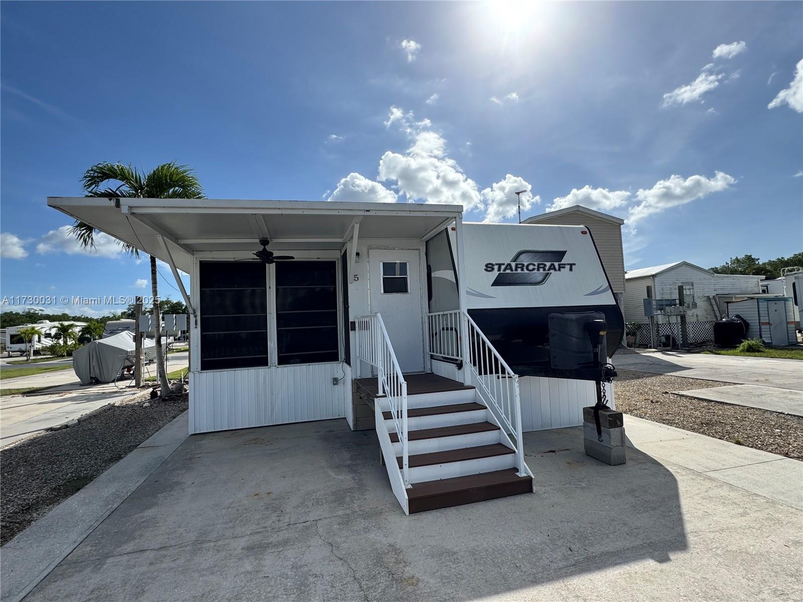 Experience the tranquil charm of Lot 5 in Fisherman's Cove, Everglades City. This exceptional property offers deeded land along with a deeded boat dock equipped with water and power, making it a perfect haven for outdoor enthusiasts. 

Facing north, this 30 x 45-foot lot accommodates a well-maintained 2015 Starcraft trailer, complete with a spacious screened-in porch and furnished to perfection.

Surrounded by The Florida Everglades, this coveted retreat is also conveniently located just a short drive from the vibrant attractions of Marco Island, Naples, and Miami. Plus, enjoy the added benefit of gated parking for your boats and trailers. Embrace the best of Florida living with this unique opportunity!