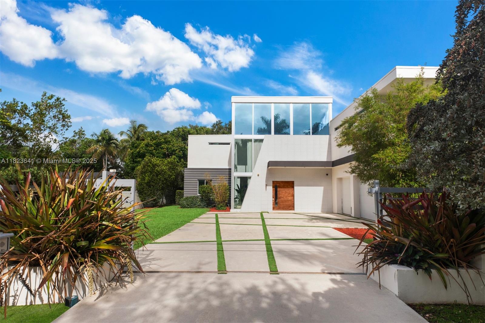 Located in the heart of Pinecrest, this gated modern estate offers luxury, privacy, and a family-friendly layout. With 6 bedrooms, 5 baths, a media room, office, and a 3-car garage with EV charging, this architecturally striking home is designed to impress. Volume ceilings and floor-to-ceiling windows flood the space with natural light. The sleek kitchen features Italian cabinetry, quartz countertops, and top-tier appliances. A floating wood staircase leads to a loft and a lavish primary suite with a private balcony. Enjoy resort-style outdoor living with a summer kitchen, pool, and spacious terrace. Minutes from top-rated schools.