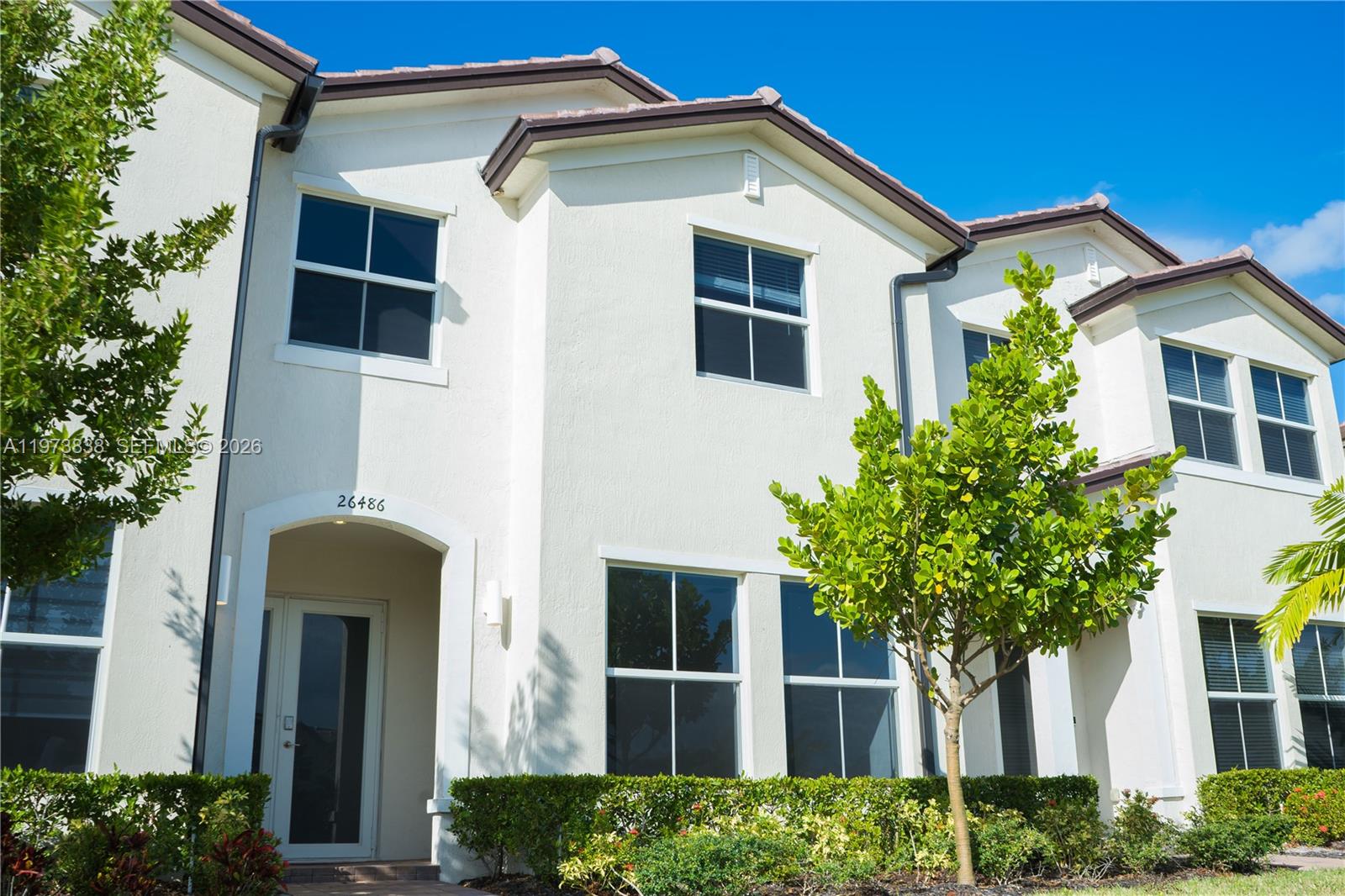Beautiful 2023 smart townhome with modern finishes and community green views. This home offers impact windows, Ring® security, 4 bedrooms / 2.5 baths, and a sleek quartz-island kitchen with walk-in pantry. Tile on the first floor and plush carpet upstairs. Enjoy a fenced patio, plus 1-car garage and 2-car driveway—a rare convenience. Low HOA ($229/month) includes fiber internet, cable, lawn care, and full access to the clubhouse, pool, and playground. Prime location near transit, US-1, the Turnpike, and Black Point Marina