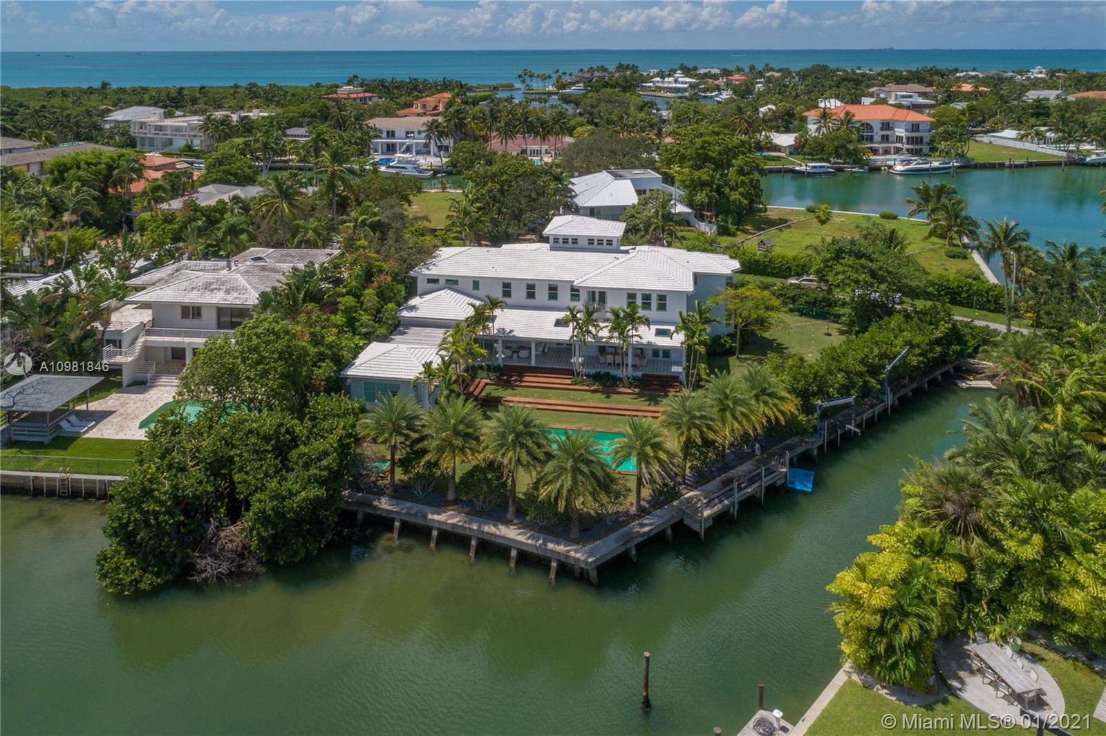 This magnificent waterfront home is the perfect setting for an amazing lifestyle. A world class estate that has been completely rebuilt with the highest level of taste,design and craftsmanship. Surrounded by water and lush landscaping this residence is warm,cozy and bright but yet elegant and unique. Offering an open floor plan that includes living room,dining room,family room and a state of the art kitchen+bar.It also has a gorgeous master suite,sitting area with 3 additional bedrooms and playroom that can be converted into a 4th bedroom for a total of 5 bedrooms and 6.5 bathrooms.Not only is this home seamless but it is also flawless with an outdoor terrace,guest house with bath,a great office(3rd floor)+2 car garage.Enjoy the incredible indoor/outdoor spaces that Florida weather offers.