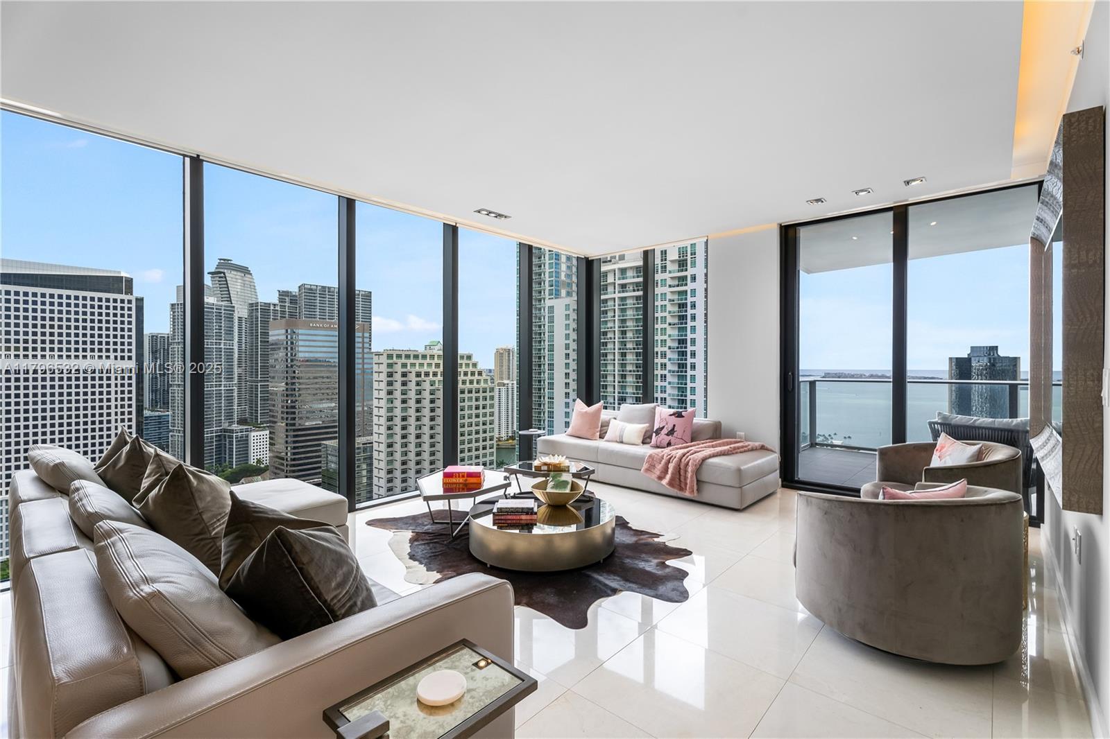 The Art of Living! Welcome to Unit #3501, a designer-furnished & turnkey corner residence in the coveted 01-line of 1010 Brickell, with nearly 1,800 SF of well-designed living space & top-tier amenities. This unit features floor-to-ceiling glass with views of the city skyline & Biscayne Bay, custom millwork upon entry & automatic shades throughout. Enjoy private elevator access, a primary suite on the east wing, & two bedrooms on the west wing, plus a converted media room with an ensuite bath, which could be used as a 4th bedroom, office, or guest suite. Includes two storage units in a prime Brickell location near top dining, shopping, & entertainment. 1010 Brickell features a rooftop pool, indoor pool, fitness center, spa, jogging track, kids’ playroom, arcade, bowling alley, & more.