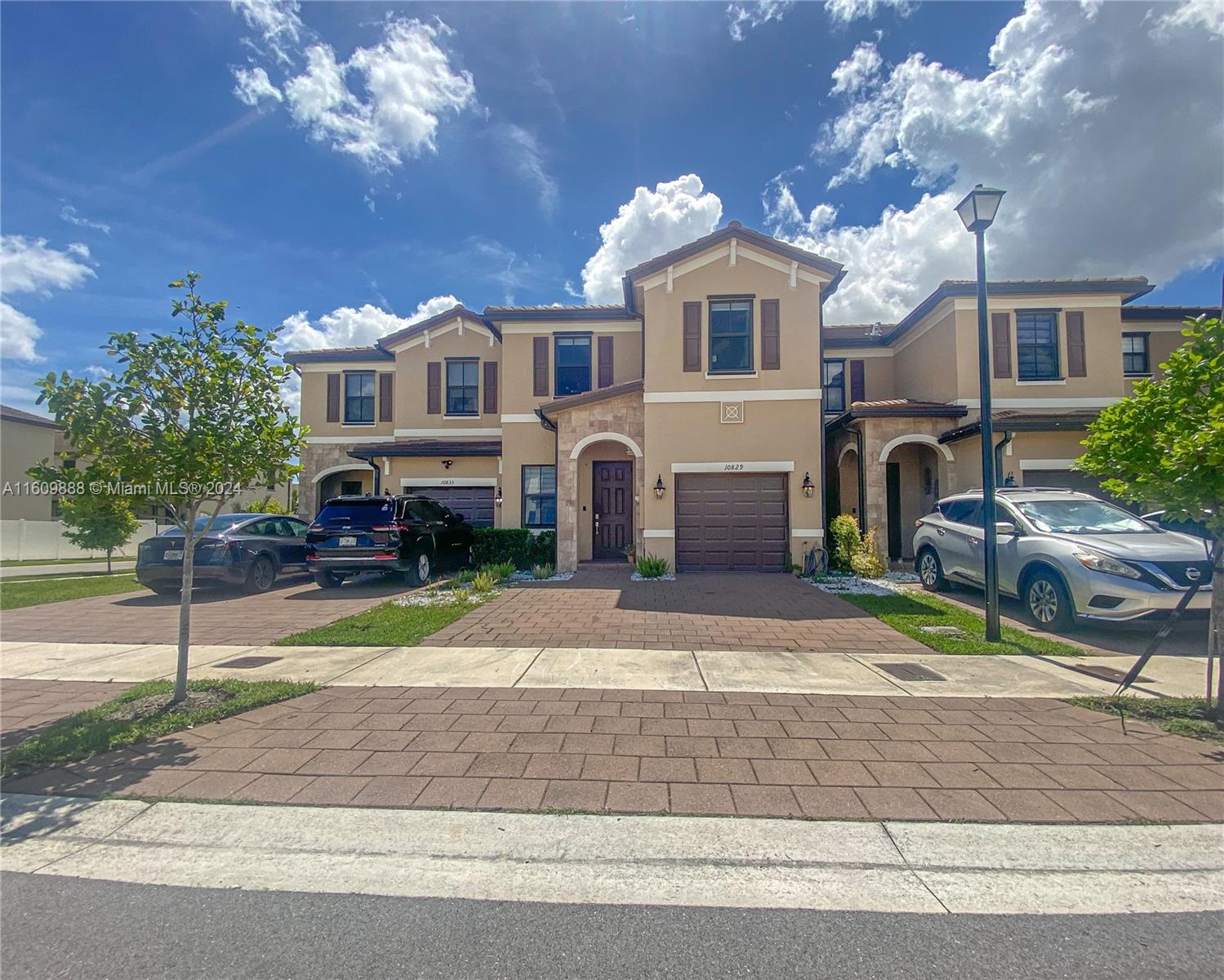 Discover your new home in the Aquabella gated community of Hialeah Gardens. This modern 2020-built townhouse offers 4 bedrooms, 2.5 bathrooms, and over 2,000 sq ft of living space, including a living room, dining room, and family space. The home features tile floors downstairs and wood flooring upstairs. Hurricane impact windows provide protection, and the kitchen has quartz countertops and stainless steel appliances. Enjoy the backyard with turf and an AC-equipped garage that can be used as a traditional garage, gym, office, or extra room. Aquabella offers resort-style pools, gyms, green areas, lakes, and play areas. Nearby are great schools and shopping centers with childcare, restaurants, shops, pharmacies, gas stations, and banks. Comfort and an active lifestyle await you.