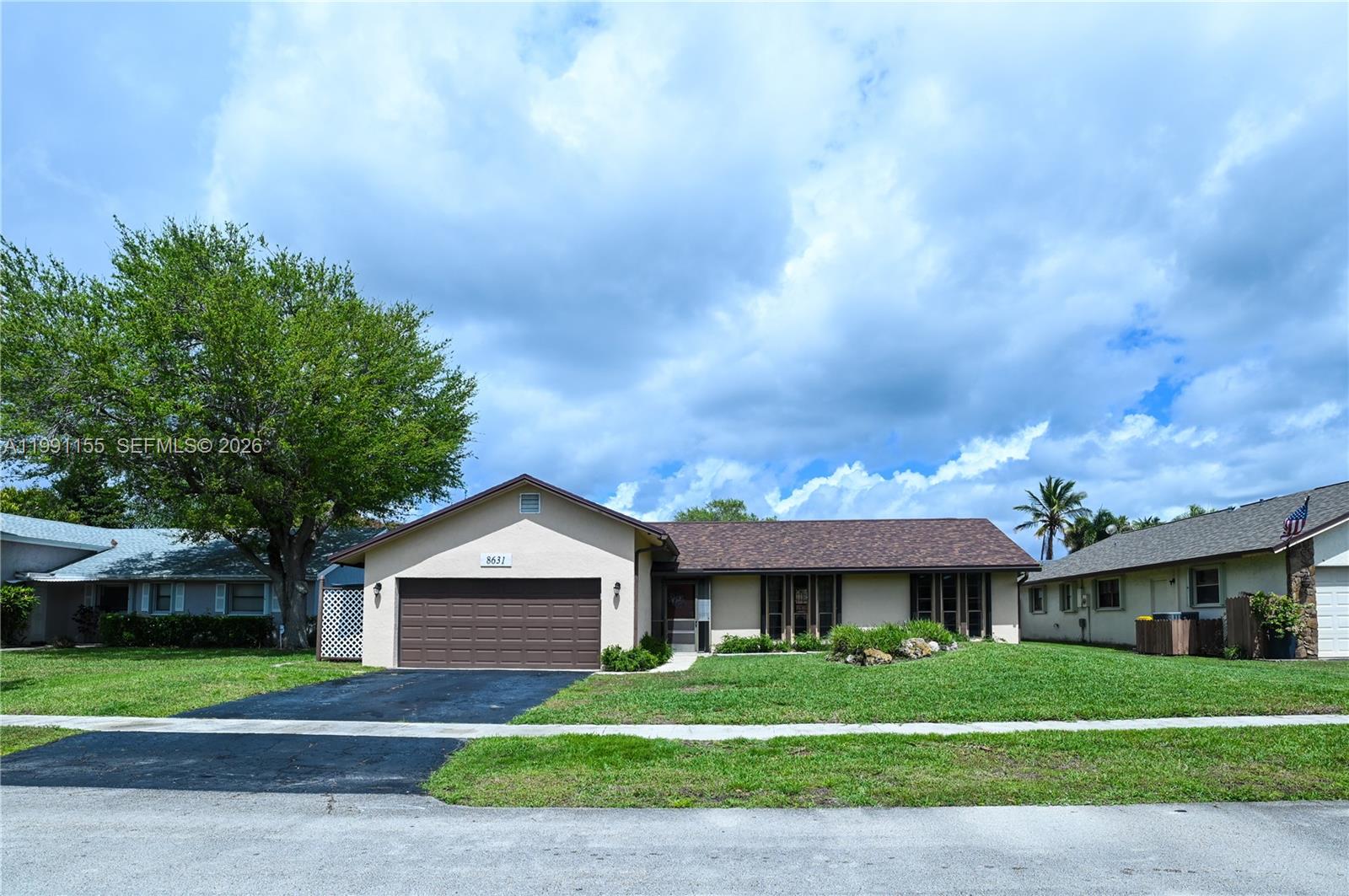 Come see this spectacular 3-bedroom 2-bathroom home with a large 2-car garage, ideally located in the highly desirable northwest area of Lauderhill. Offering both comfort and functionality, this residence features a spacious open split floor plan designed for modern living. Step inside to find beautiful wood-look tile flooring flowing throughout the living area and bedrooms. The home boasts generously sized bedrooms, abundant closet space, and tastefully updated primary and guest bathrooms, creating a move-in-ready experience. Enjoy peace of mind with a newer roof (approximately 5 years old) and accordion hurricane shutters for added storm protection. With no HOA, you’ll appreciate the added flexibility and freedom. Outdoor living is just as impressive, featuring a huge screened-in patio perfect for relaxing or entertaining, along with a large fenced-in backyard offering plenty of space for gatherings or even your future pool. Conveniently located near parks, shopping, and everyday amenities, this home truly has it all. Don’t miss this incredible opportunity to own a beautiful property in one of Lauderhill’s most sought-after neighborhoods! A MUST SEE!!