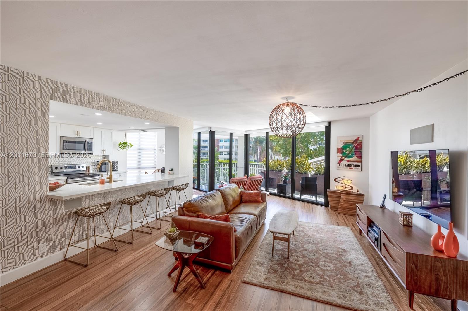 This beautifully renovated and spacious 2-bedroom, 2-bath unit on the 3rd floor offers serene water views from the balcony and convenient same-level access to the pool. The formal dining room can be easily converted into a 3rd bedroom for added flexibility. Features include bamboo floors, quartz countertops, impact windows, electric blinds, a built-in surround sound system with a 65" OLED TV, and a wine cooler. Located in a unique Miami waterfront community with resort-style amenities: spa, tennis, pickleball, marina with restaurant, and 24/7 security. A warm, welcoming neighborhood offering events, wellness programs, and activities for all ages. Monthly maintenance includes water, hot water, cable, high-speed internet, and daily classes.