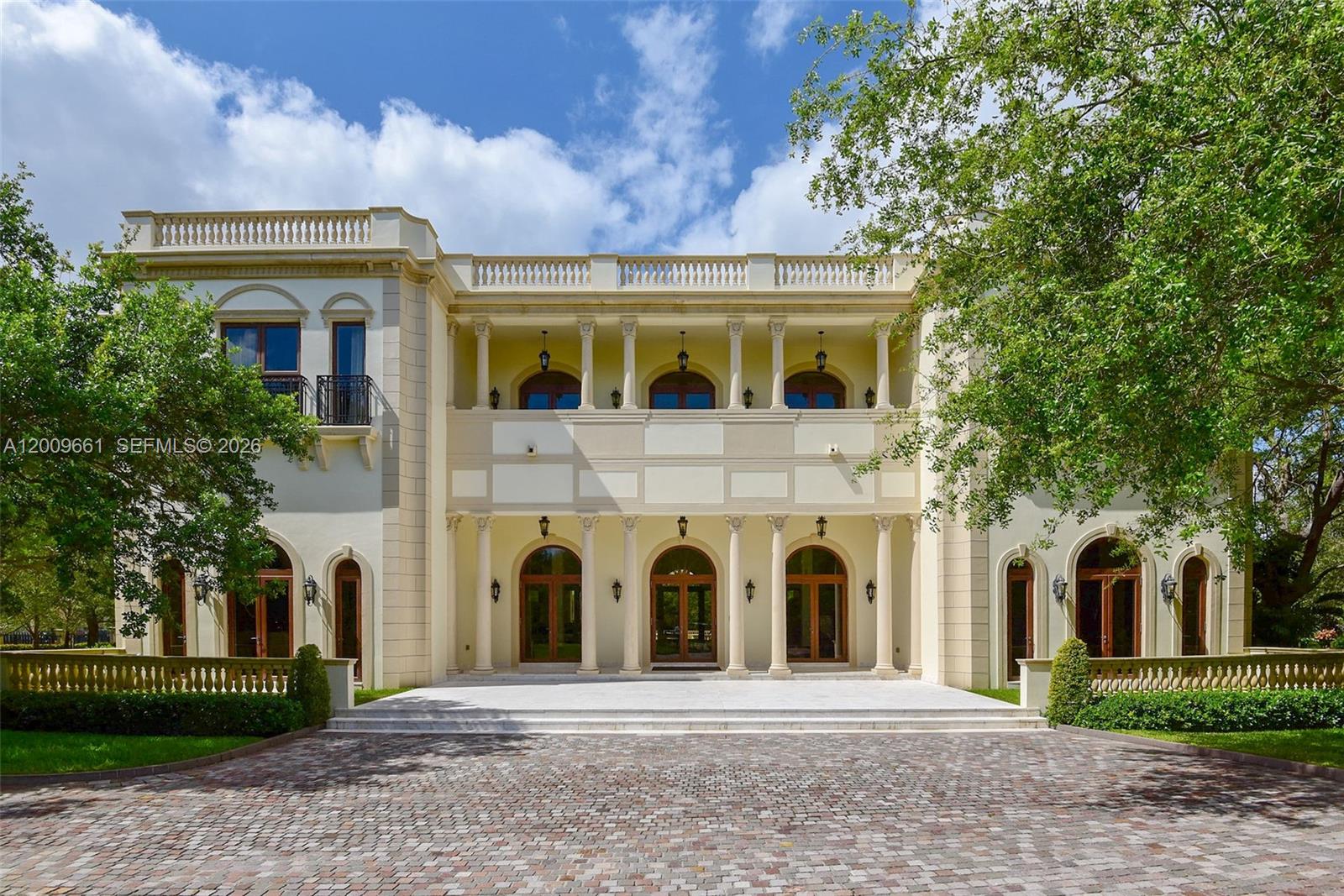 Maison du Parc is a landmark estate along the prestigious Moss Ranch Road corridor, set on 1.3 acres and spanning over 15,235 SF, standing among the largest and most distinguished properties in Pinecrest. This grand European-inspired residence blends timeless elegance with modern luxury, featuring soaring 18-ft ceilings, a dramatic arched foyer, 48x48 glass tile flooring, and imported La Finestra windows and doors that fill the home with natural light. Designed for elevated living and exceptional entertaining, the estate offers separate guest quarters, expansive formal and informal spaces, and seamless indoor-outdoor flow to resort-style grounds with an infinity-edge pool and spa, dual summer kitchens, a lily reflection pond, and manicured lawns. Advanced amenities include full Crestron and Lutron systems, a 16-seat home theater, elevator, and a striking 1,200-bottle refrigerated wine and cigar cellar—delivering a rare combination of scale, architectural presence, and prestige in one of Pinecrest’s most coveted locations.