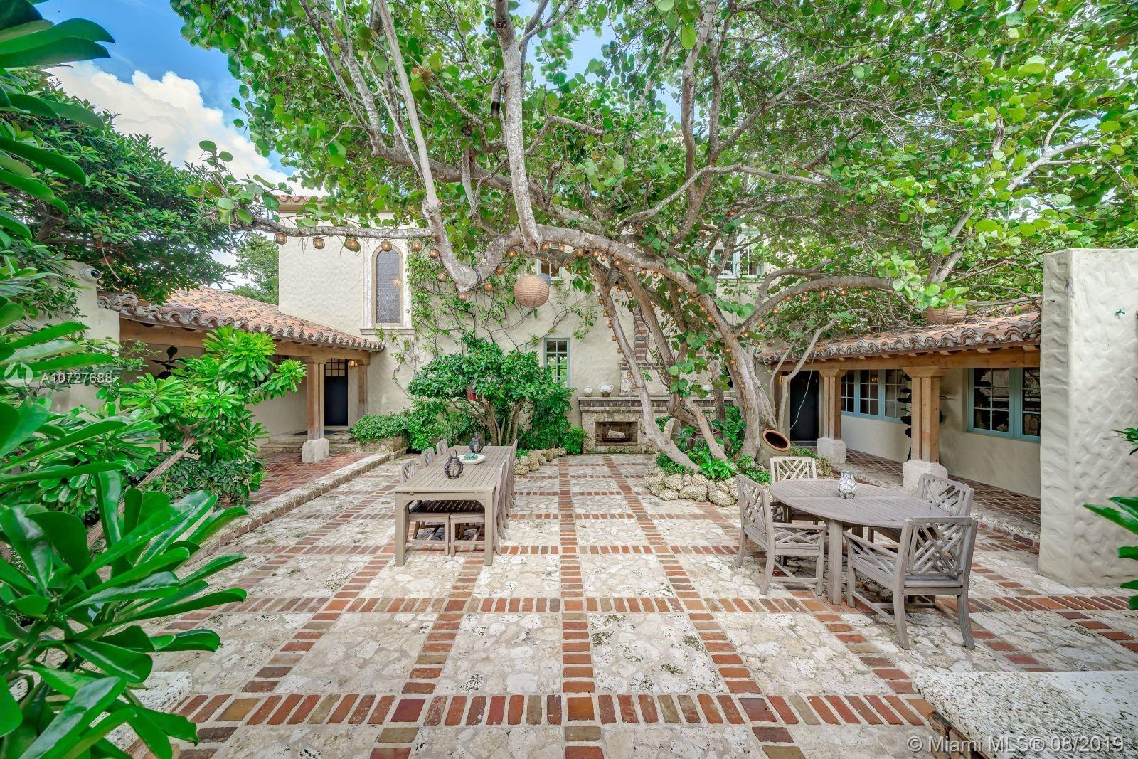 Designed with the laid-back luxury of California wine country in mind, this home is a study in a quiet elegance. Oversized lot is lusciously landscaped. Massive wood doors lead to a courtyard wonderland. Exquisite back patios, and terraced gardens extend the living area to the great outdoors. This is no ordinary setting! Inside you will find an extraordinary depth of detail. Gutted to the studs & restored to perfection. Italian wood plank & stone floors. The kitchen with 2 sinks & huge island/eat-in area opens to the courtyard & the formal dining rm. Master has His/Hers closets, sitting area and fireplace. 62 ft dock, newly capped seawall, 2-car garage & proper laundry room. Highest natural elevation on Miami Beach. Walk to the Ocean, restaurants, clubs, hotels, museums, the ballet etc.