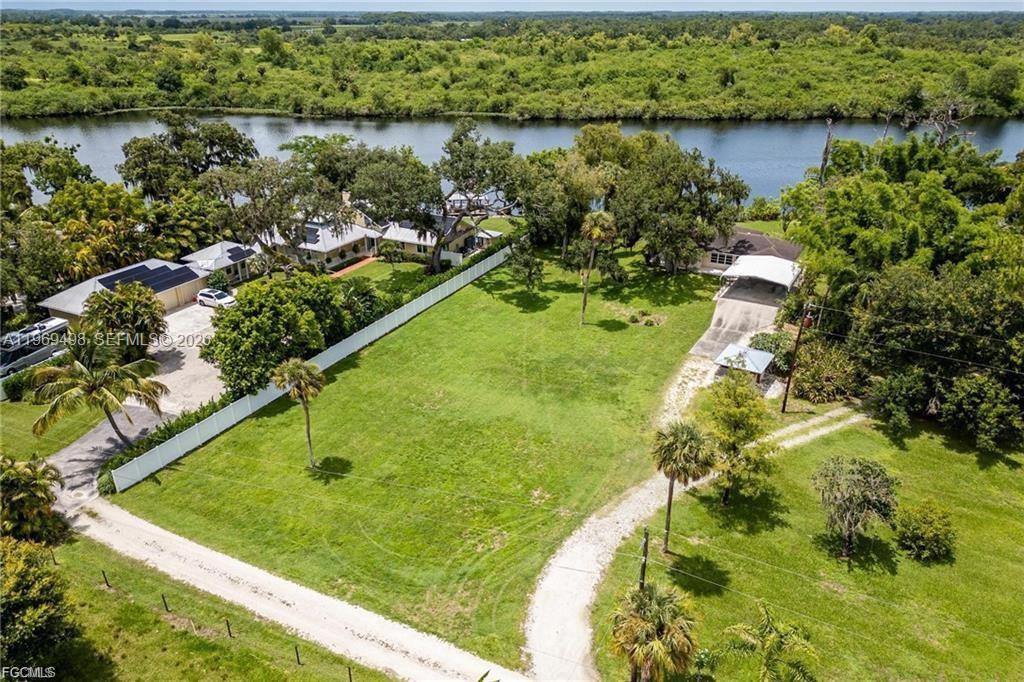Enjoy Intracoastal riverfront living in the historic Ft. Denaud area with 131+/- feet on the river on 1.03+/- acres! Located on the banks of the Caloosahatchee River, with deep water access to The Gulf of Mexico, Atlantic Ocean, and Lake Okeechobee, this property is protected from storm surge and tides by locks. The home has been a tranquil winter getaway for many years and it is ready for new owners to enjoy! Located just outside of the city limits in one of the nicest parts of the LaBelle area, the cozy home is perfect as a winter retreat, weekend getaway, or the waterfront home you have always dreamed of. The home has amazing river views and with updating can really be a showplace! The riverbank is slopped to the dock, which features two lifts, and is the perfect spot to start enjoying all of your new boating river adventures. (THIS HOME IS NOT IN A FLOOD ZONE AND IS NOT SUBJECT TO TIDES OR STORM​​‌​​​​‌​‌​​​‌‌​​​‌‌‌​​‌​​‌‌​​​​ SURGE.)